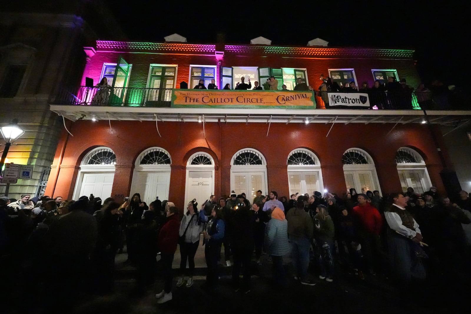 Parade attendees toast to victims of the deadly New Years truck attack, during the annual Krewe de Jeanne d'Arc parade, kicking off the Mardi Gras season, in New Orleans, Monday, Jan. 6, 2025. (AP Photo/Gerald Herbert)