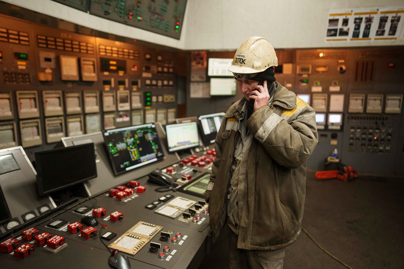 A worker speaks by mobile phone inside operating room at DTEK's power plant after a recent Russian missile attack in Ukraine, Nov. 28, 2024. (AP Photo/Evgeniy Maloletka)