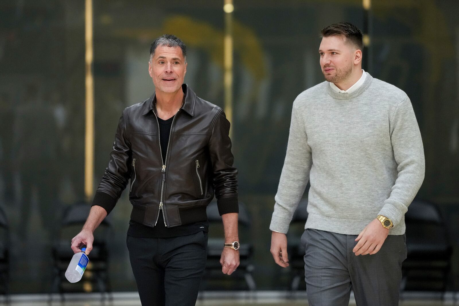 Los Angeles Lakers' Luka Doncic, left, walks to the podium with general manger Rob Pelinka during an introductory NBA basketball press conference Tuesday, Feb. 4, 2025, in El Segundo, Calif. (AP Photo/Jae C. Hong)