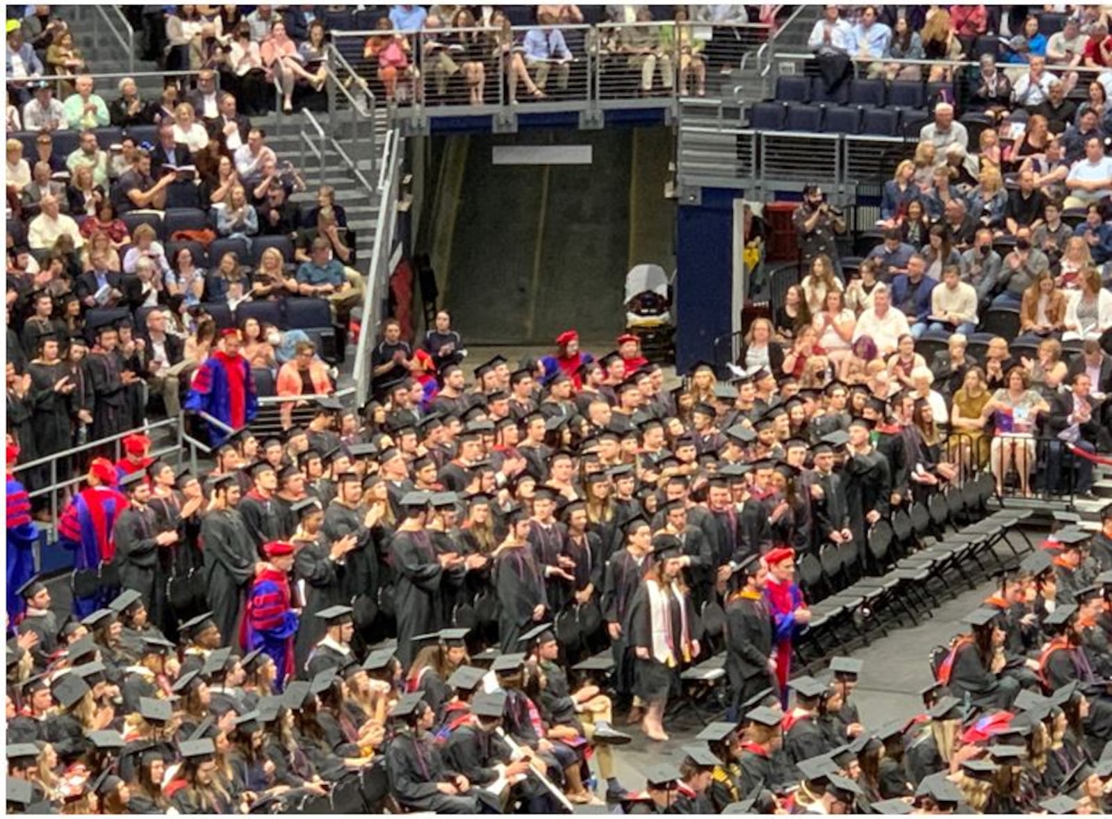 Another group of students take their place in line to receive their diplomas during Sunday's graduation ceremonies at the University of Dayton. ED RICHTER/STAFF