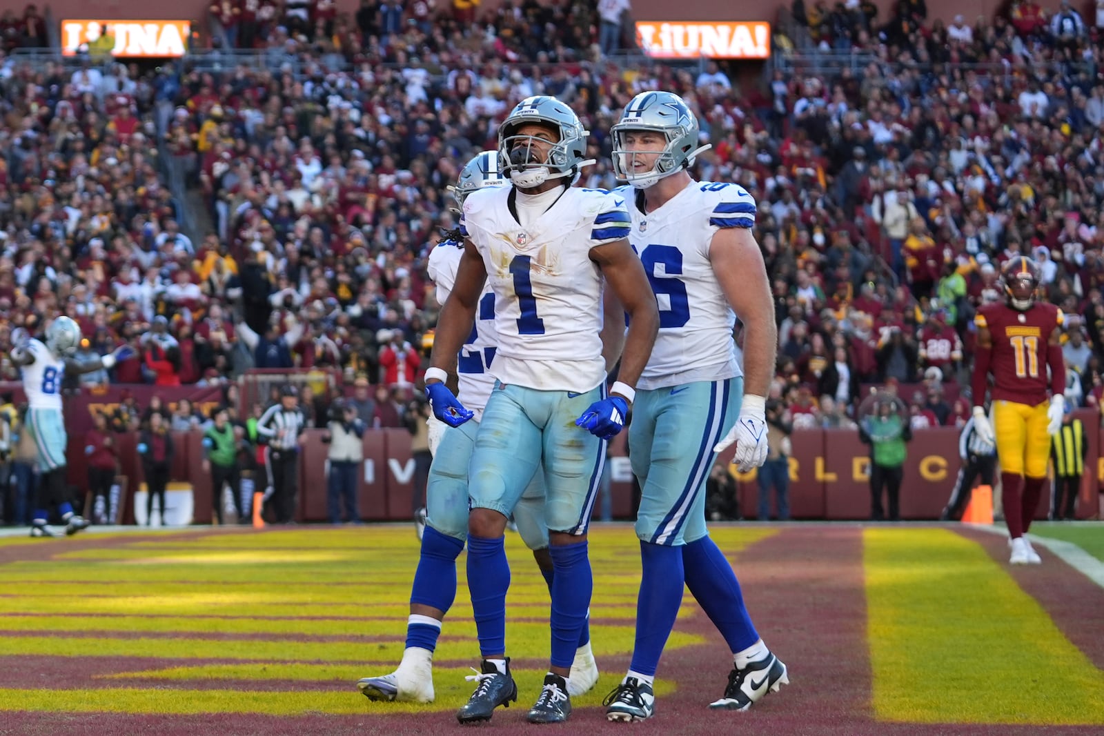 Dallas Cowboys wide receiver Jalen Tolbert (1) celebrates after scoring a 6-yard touchdown during the second half of an NFL football game against the Washington Commanders, Sunday, Nov. 24, 2024, in Landover, Md. (AP Photo/Stephanie Scarbrough)