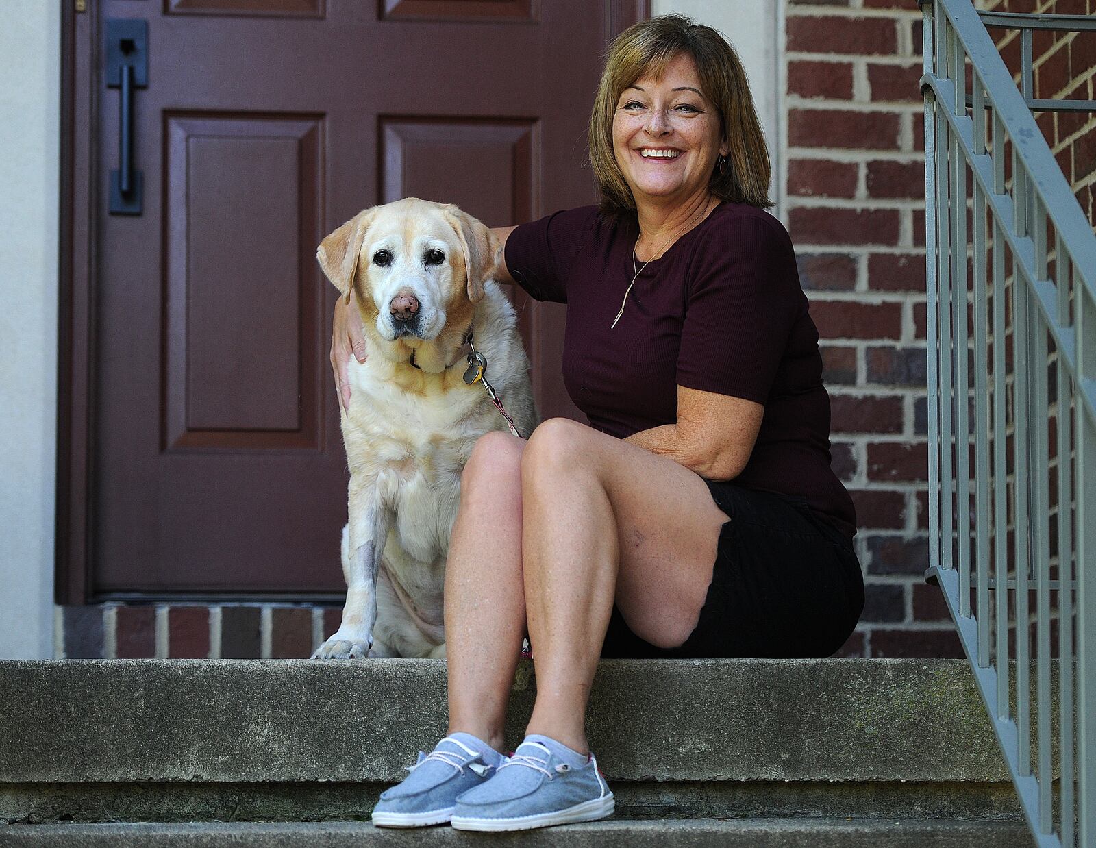 Tracy Landgren, with her dog Bella. Landgren has been living with long COVID. MARSHALL GORBY\STAFF