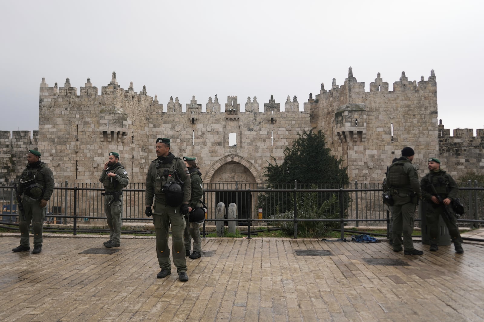 Israeli Border Police stand guard at the Damascus Gate to the Old City of Jerusalem as worshippers make their way to the Al-Aqsa Mosque compound for the first Friday Prayers of the Muslim holy month of Ramadan, Friday, March 7, 2025. (AP Photo/Mahmoud Illean)