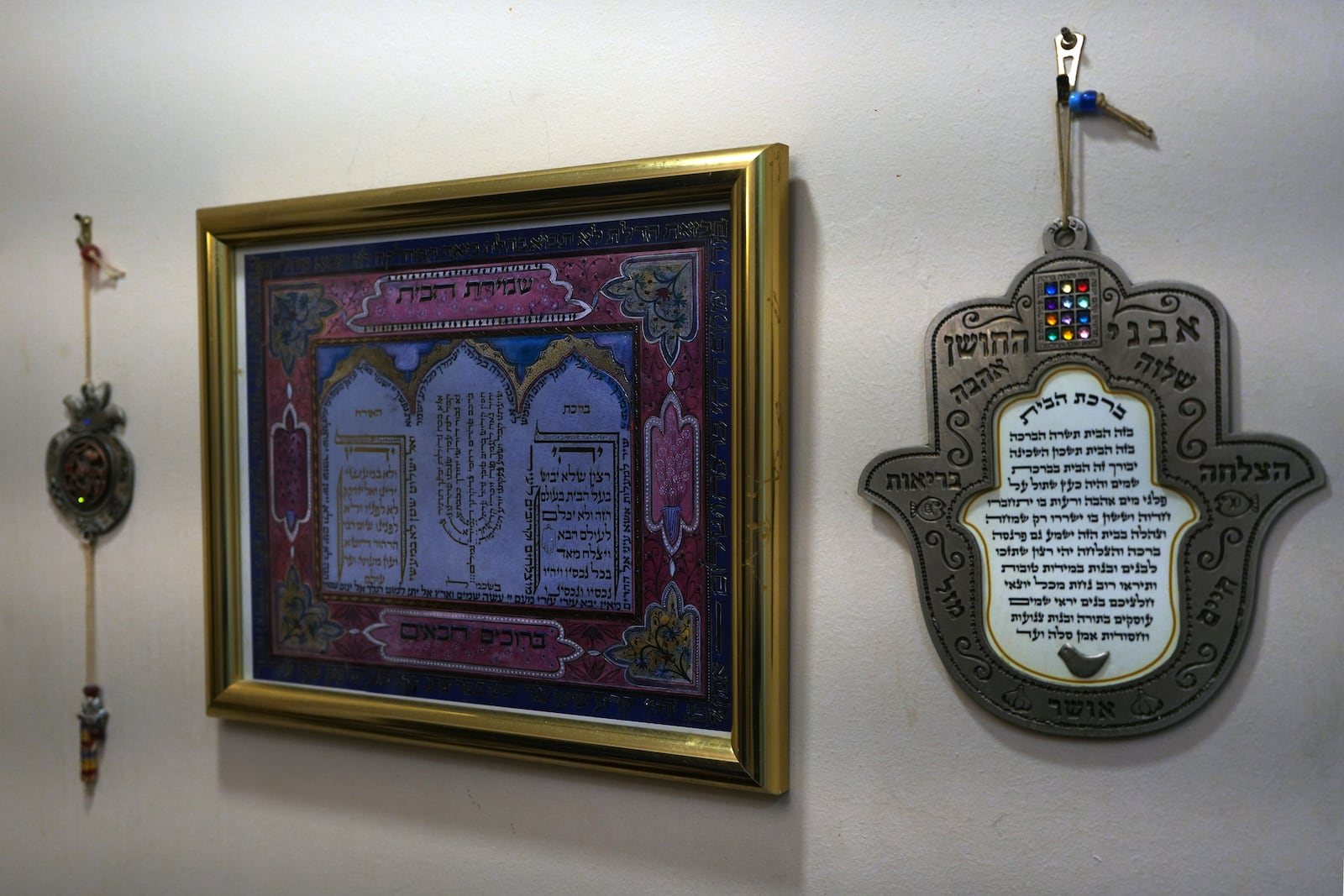 Jewish blessings for the home hang from a wall at the entrance of the Marcus family home at in Teaneck, N.J., on Friday, Dec. 20, 2024. (AP Photo/Luis Andres Henao)