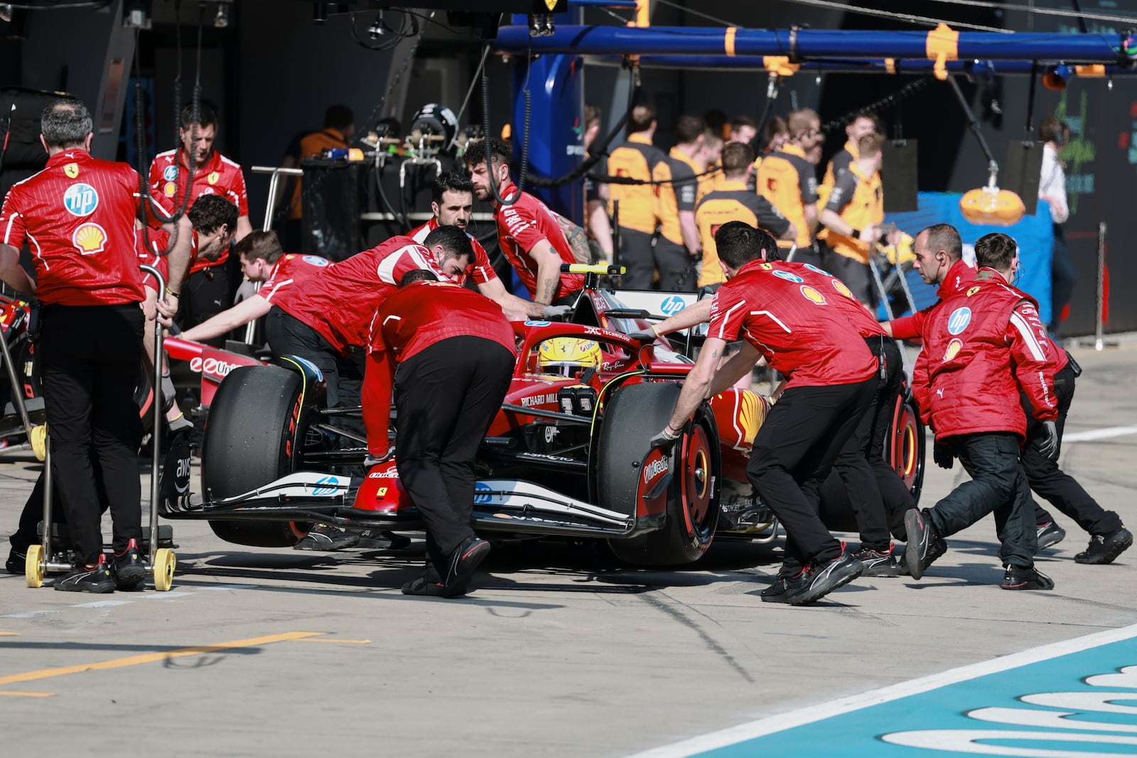 Ferrari driver Lewis Hamilton of Britain gets pushed back into his garage during qualifying session for the Chinese Formula One Grand Prix at the Shanghai International Circuit, Shanghai, Saturday, March 22, 2025. (Wo Hao/Pool Photo via AP)