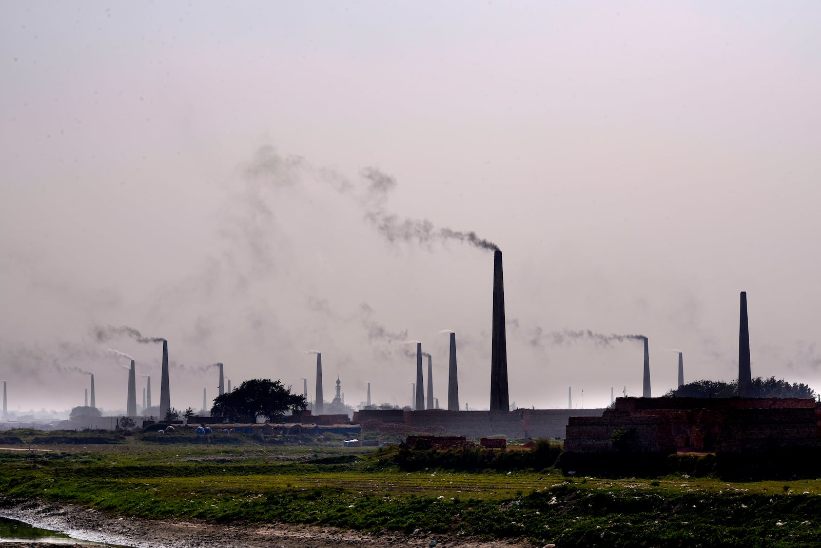 Smoke rises from chimneys of brick kilns on the outskirts of Dhaka, Bangladesh, on Feb. 9, 2025. (AP Photo/Mahmud Hossain Opu)