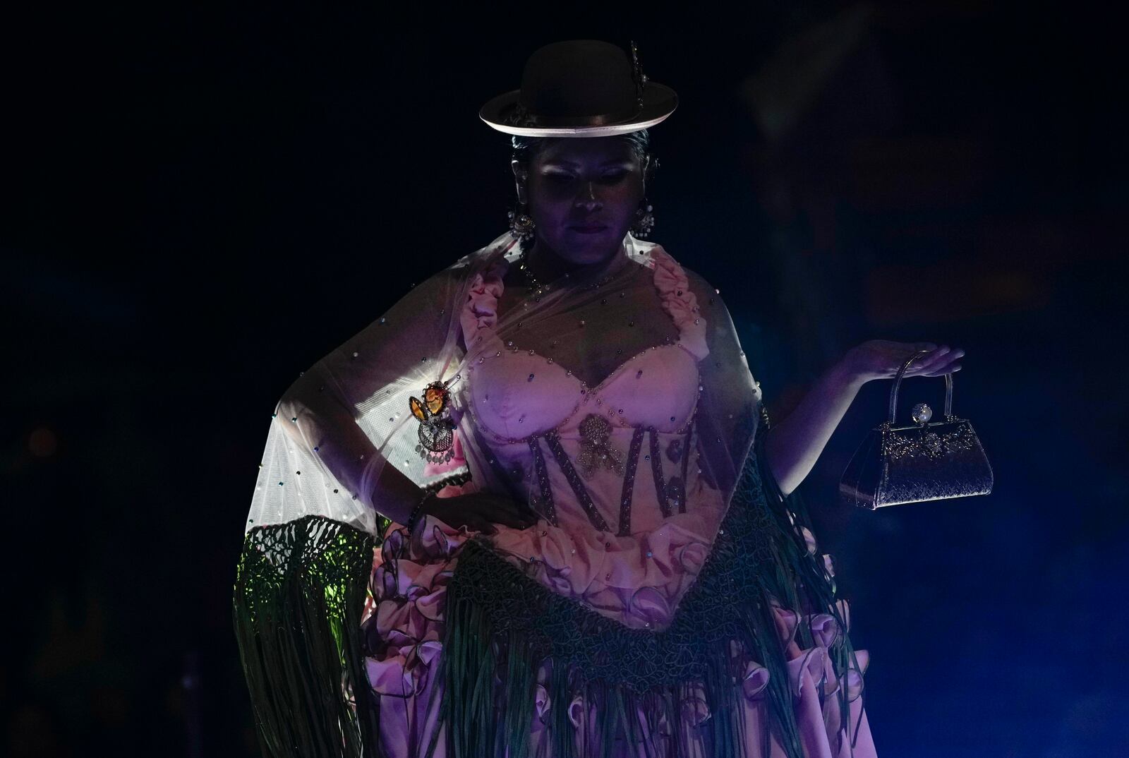 A woman models a creation by a local designer at a Chola fashion show, promoting the Andean style and beauty of Aymara women, in Viacha, Bolivia, Friday, Nov. 29, 2024. (AP Photo/Juan Karita)