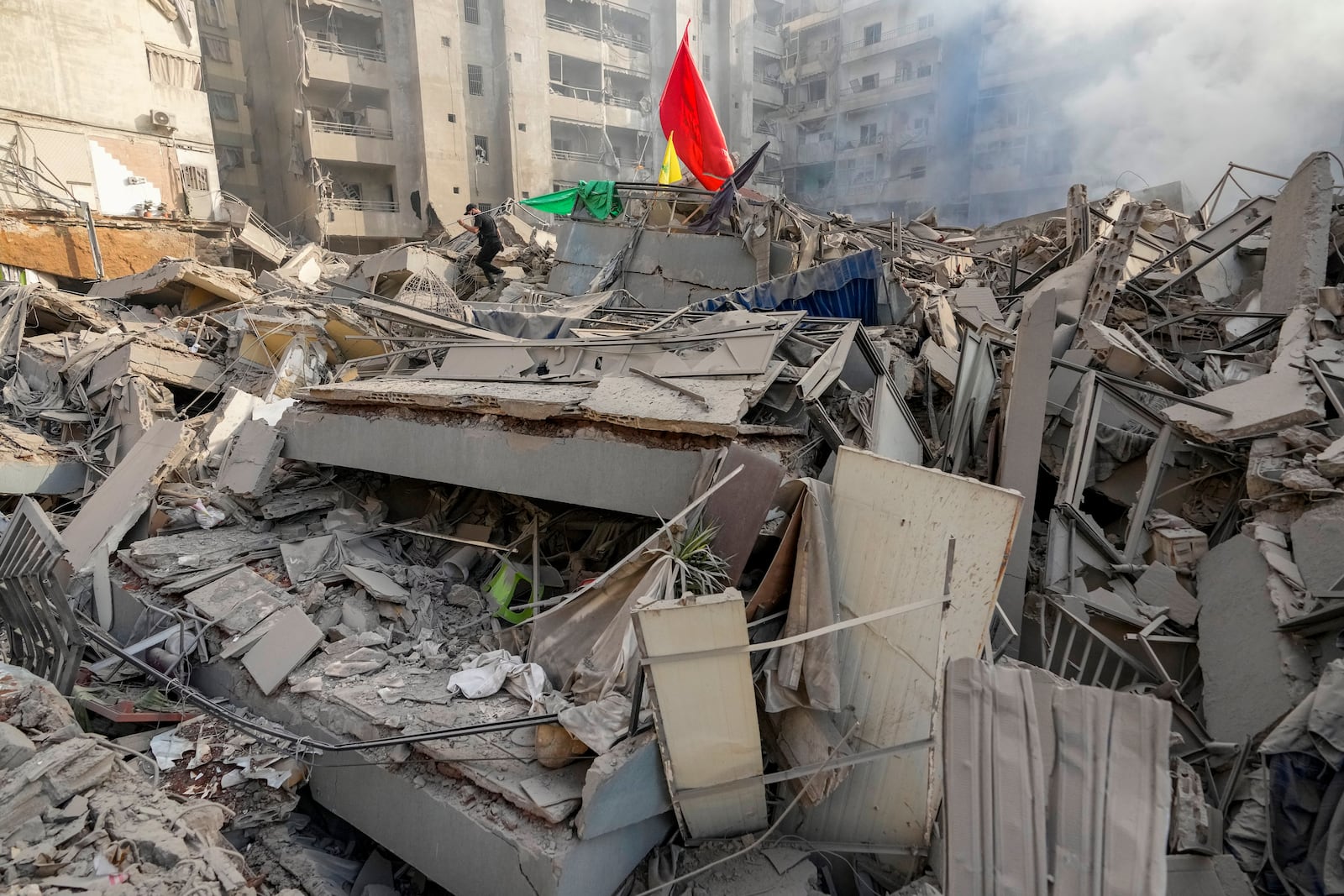 A man walks on the rubble of his destroyed apartment following an Israeli airstrike in Dahiyeh, Beirut, Lebanon, Friday, Nov. 1, 2024. (AP Photo/Hassan Ammar)