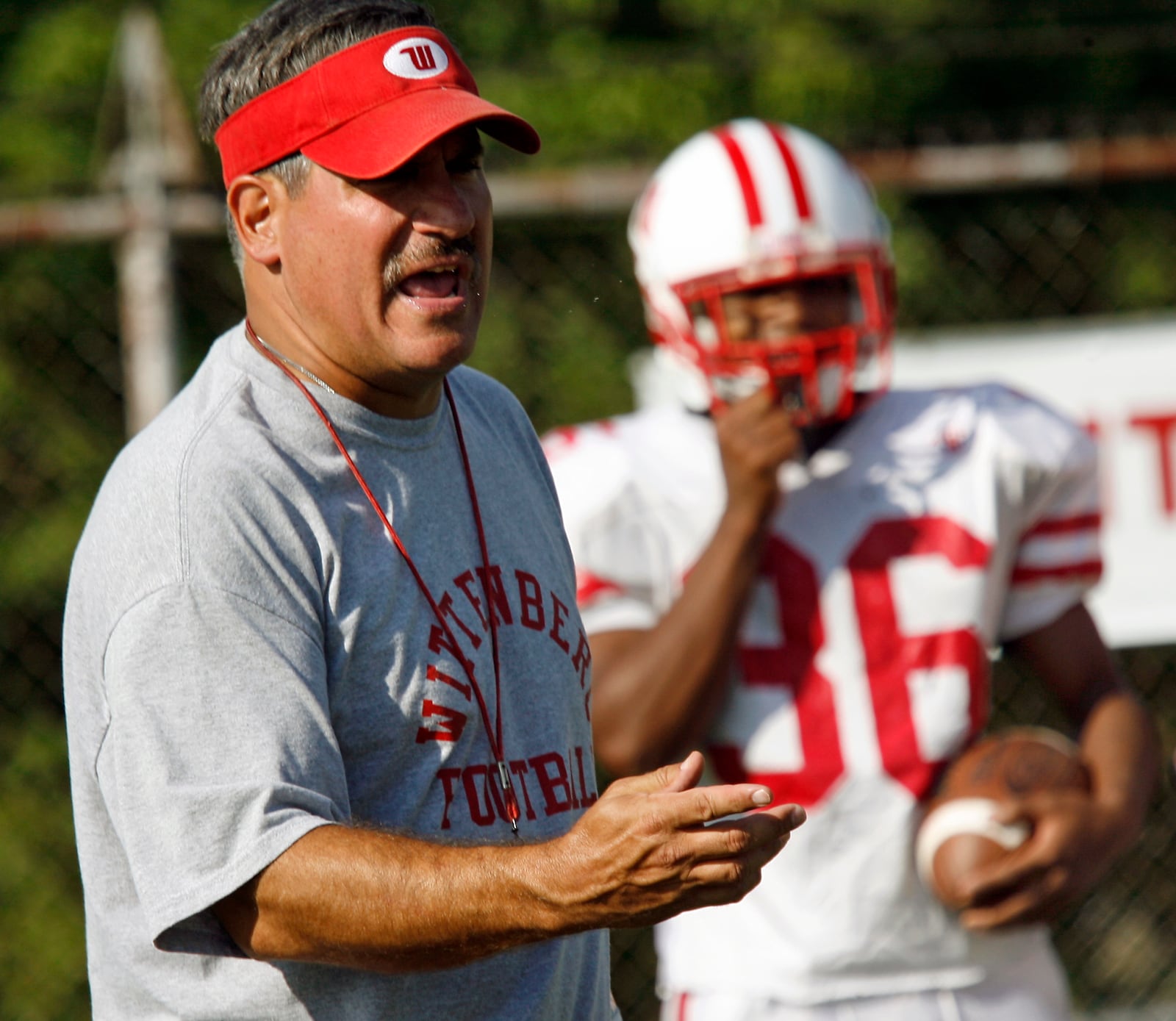 Wittenberg assistant coach Mark Ewald talks to the running backs Wednesday, Sept. 16, in practice. Ewald is the only assistant on Joe Fincham’s staff to be there all 14 seasons.