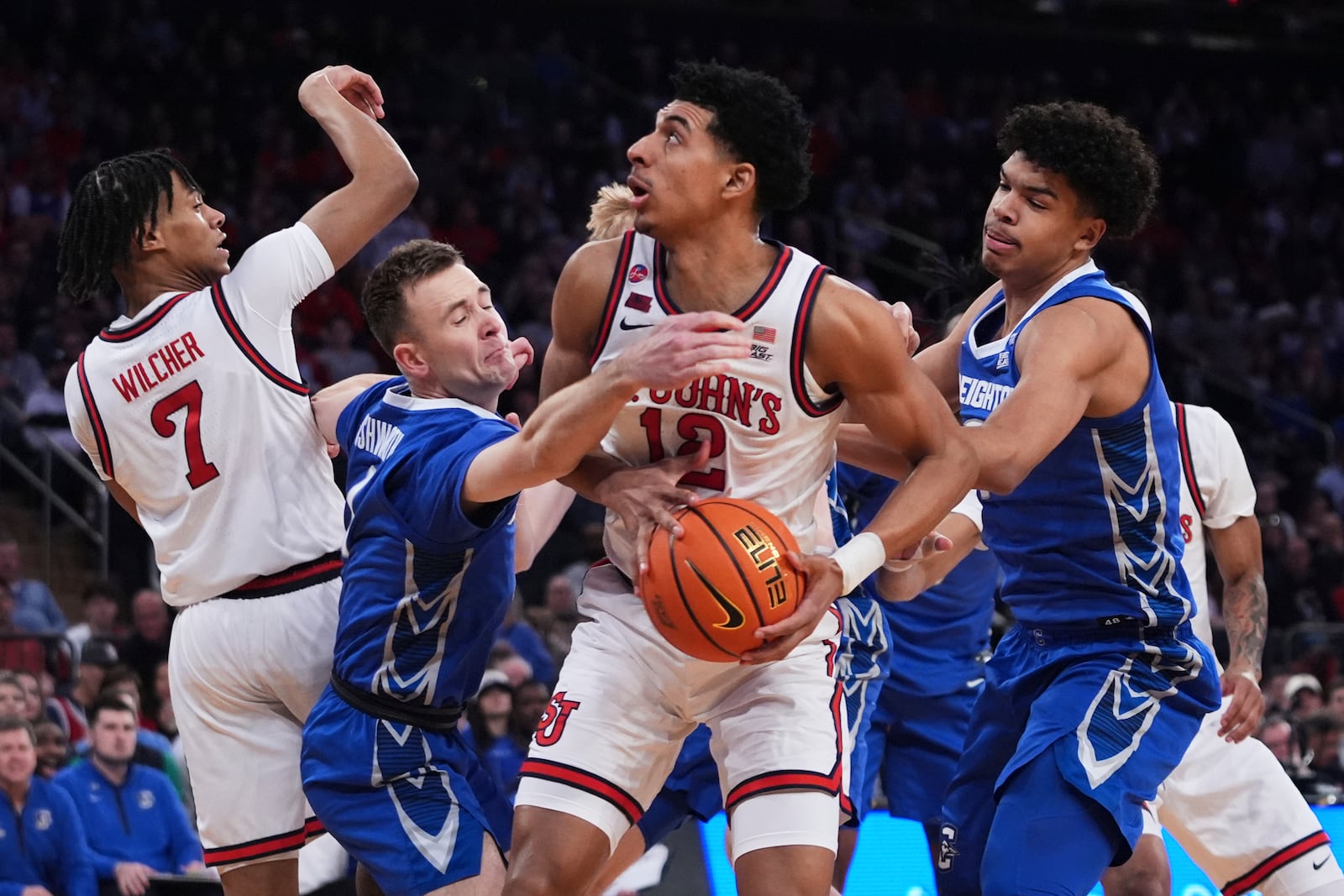 Creighton's Steven Ashworth, second from left, and Jasen Green, right, defend against St. John's's RJ Luis Jr. (12) during the first half of an NCAA college basketball game in the championship of the Big East Conference tournament Saturday, March 15, 2025, in New York. (AP Photo/Frank Franklin II)