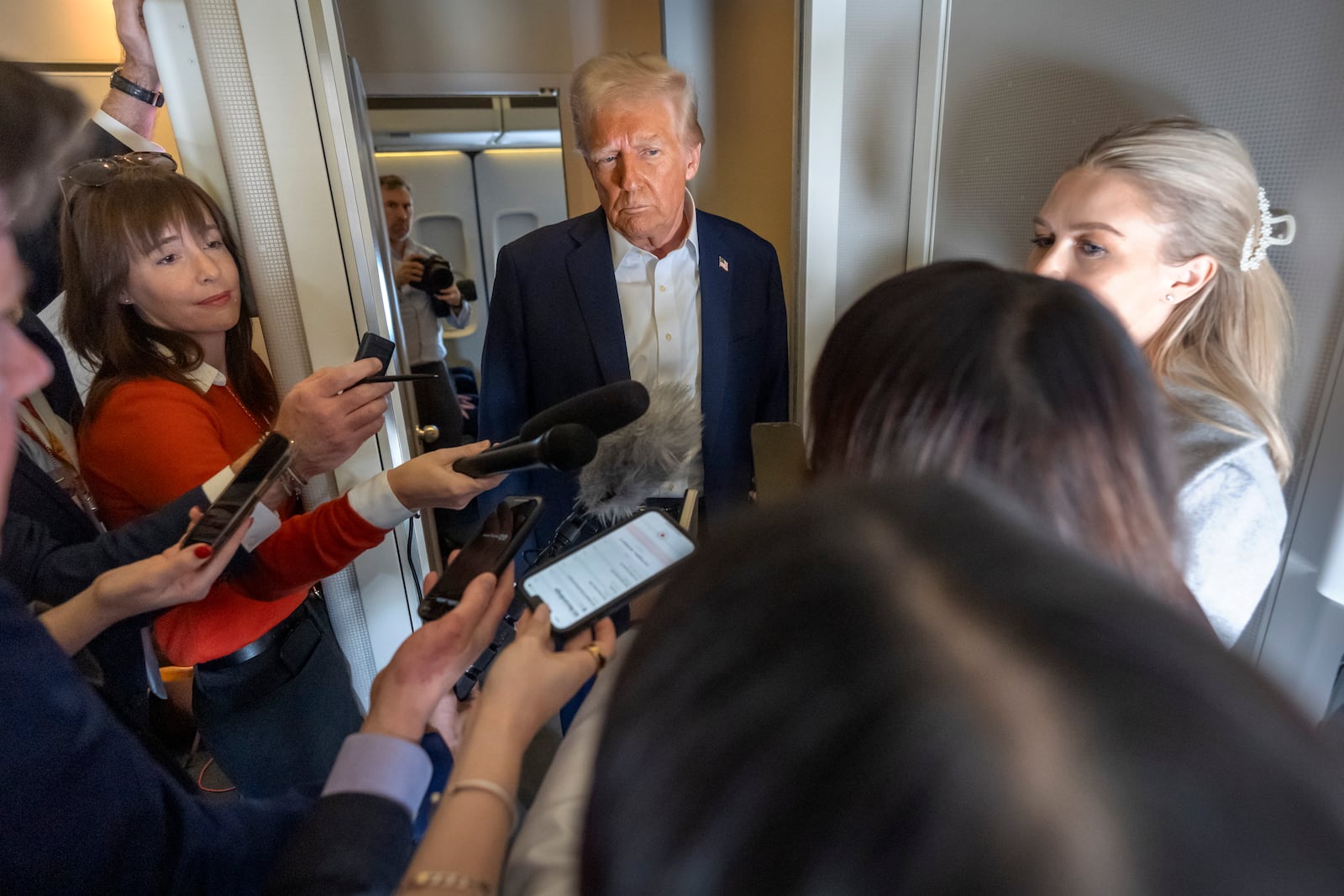 President Donald Trump speaks to reporters aboard Air Force One as he travels from Las Vegas to Miami on Saturday, Jan. 25, 2025. (AP Photo/Mark Schiefelbein)