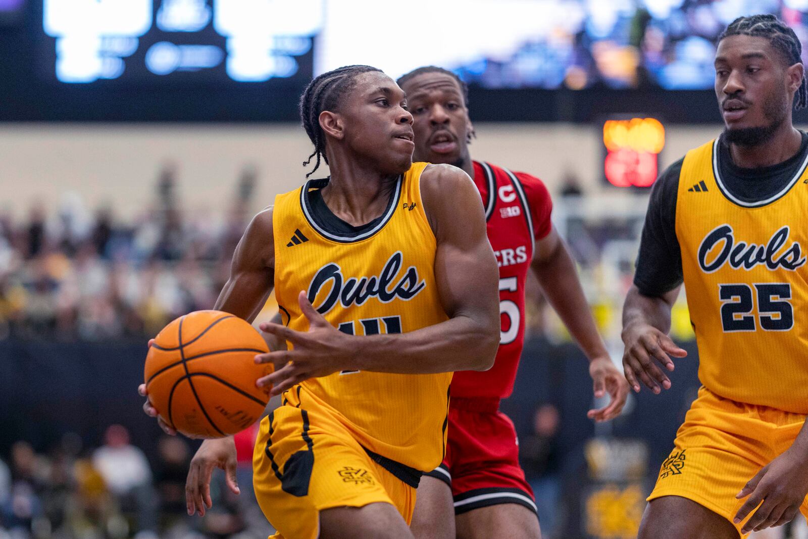 Kennesaw State guard Adrian Wooley (14) attempts to pass the ball during the first half of an NCAA college basketball game against Rutgers, Sunday, Nov. 24, 2024, in Kennesaw, Ga. (AP Photo/Erik Rank)