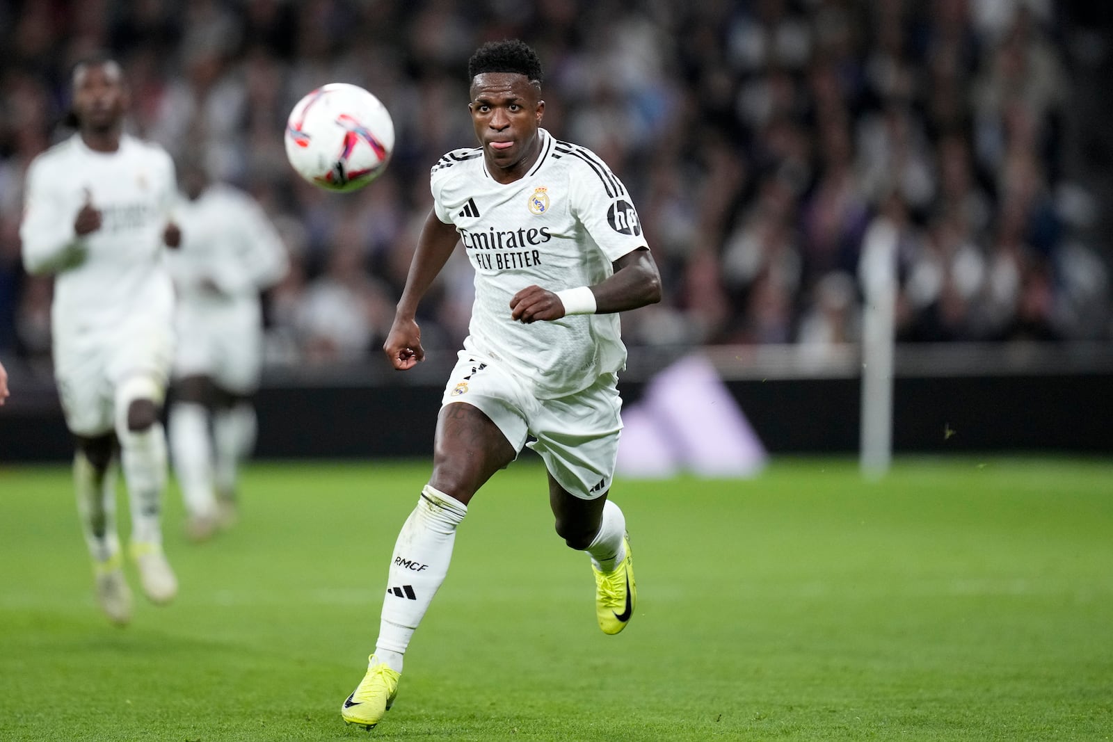 Real Madrid's Vinicius Junior runs with the ball during a Spanish La Liga soccer match between Real Madrid and Barcelona at the Santiago Bernabeu stadium in Madrid, Spain, Saturday, Oct. 26, 2024. (AP Photo/Bernat Armangue)