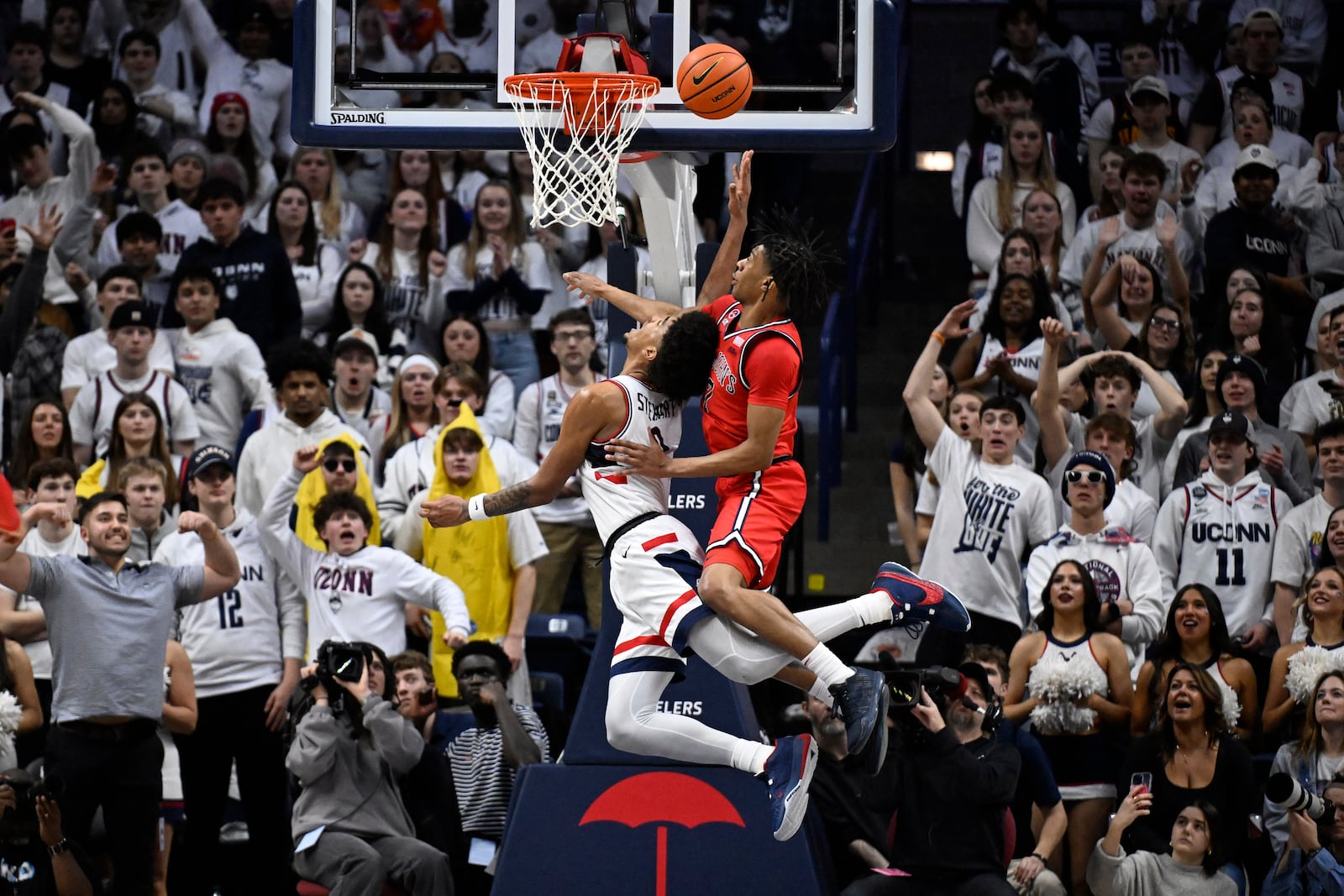 St. John's guard Deivon Smith, top, is called for a flagrant foul as UConn forward Jaylin Stewart attempts a dunk in the first half of an NCAA college basketball game, Friday, Feb. 7, 2025, in Storrs, Conn. (AP Photo/Jessica Hill)