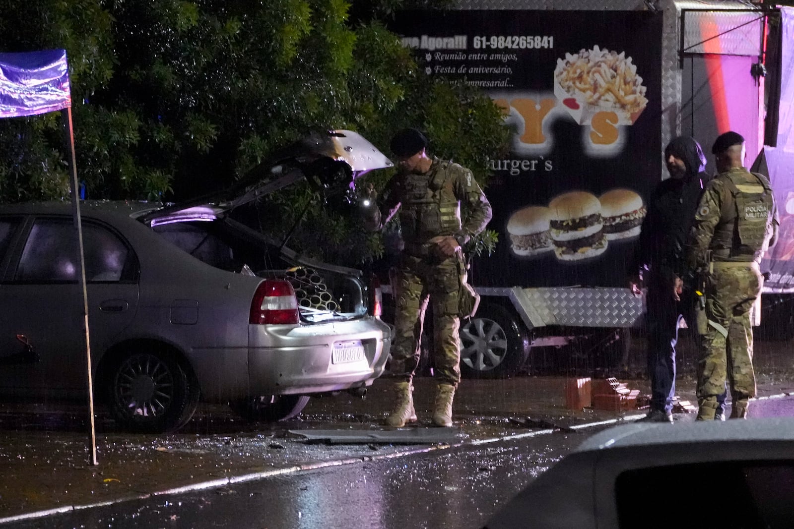 Police inspect a vehicle outside the Supreme Court in Brasília, Brazil, following an explosion, Wednesday, Nov. 13, 2024. (AP Photo/Eraldo Peres)