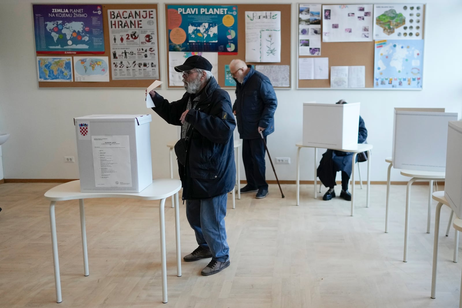 A man casts his ballot during presidential elections, at a polling station in Zagreb, Croatia, Sunday, Dec. 29, 2024. (AP Photo/Darko Bandic)