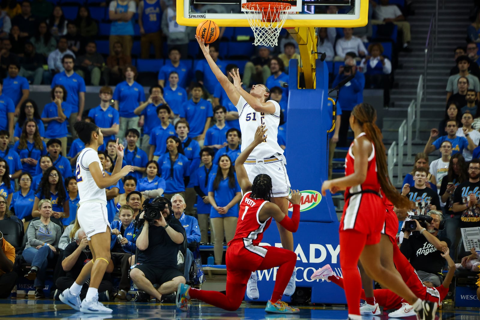 UCLA center Lauren Betts (51) shoots as forward Kendall Dudley Ohio State forward Ajae Petty (1), and Ohio State guard Chance Gray watch during the first half of an NCAA college basketball game Wednesday, Feb. 5, 2025, in Los Angeles. (AP Photo/Jessie Alcheh)