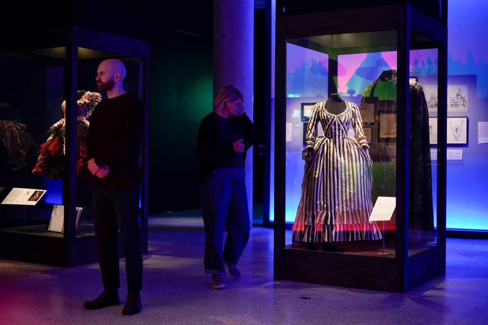 People walk at The World of Tim Burton exhibition at the Design Museum, in London, Monday, Oct. 21, 2024. The major exhibition sees Tim Burton's personal archives on display for the first time, featuring 600 items from his nearly fifty years long career. (AP Photo/Alberto Pezzali)