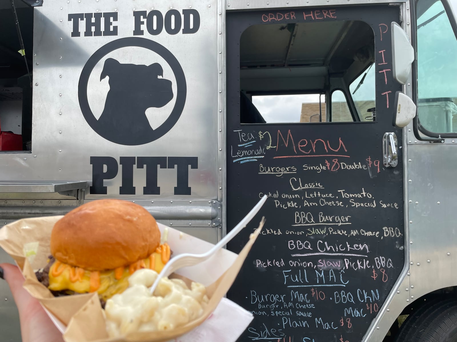 Austin Warman and Justin Hamilton own and operate The Food Pitt, a Dayton-region food truck serving smash burgers and homemade macaroni and cheese. They say it can take two days to prep for five days of events. NATALIE JONES/STAFF