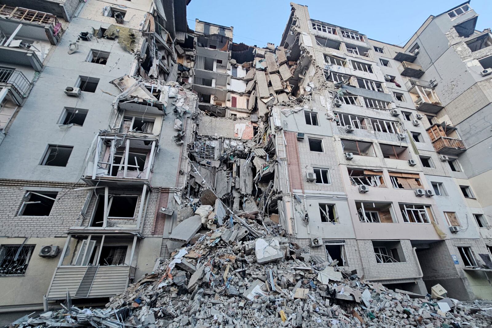 In this photo provided by the Kherson Regional Military Administration on Thursday, Feb. 20, 2025, a multi-story building is seen heavily damaged by a Russian strike on a residential neighbourhood in Kherson, Ukraine. (Kherson Regional Military Administration via AP)