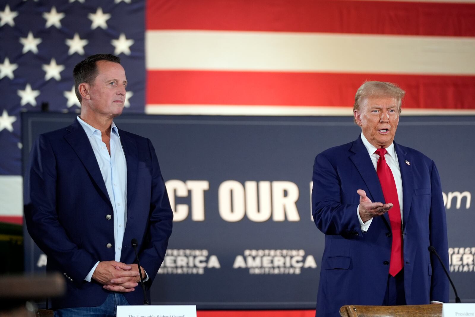 FILE - Then former President Donald Trump speaks next to Richard Grenell during a presidential election campaign event at a farm in Smithton, Pa., Sept. 23, 2024. (AP Photo/Alex Brandon, File)