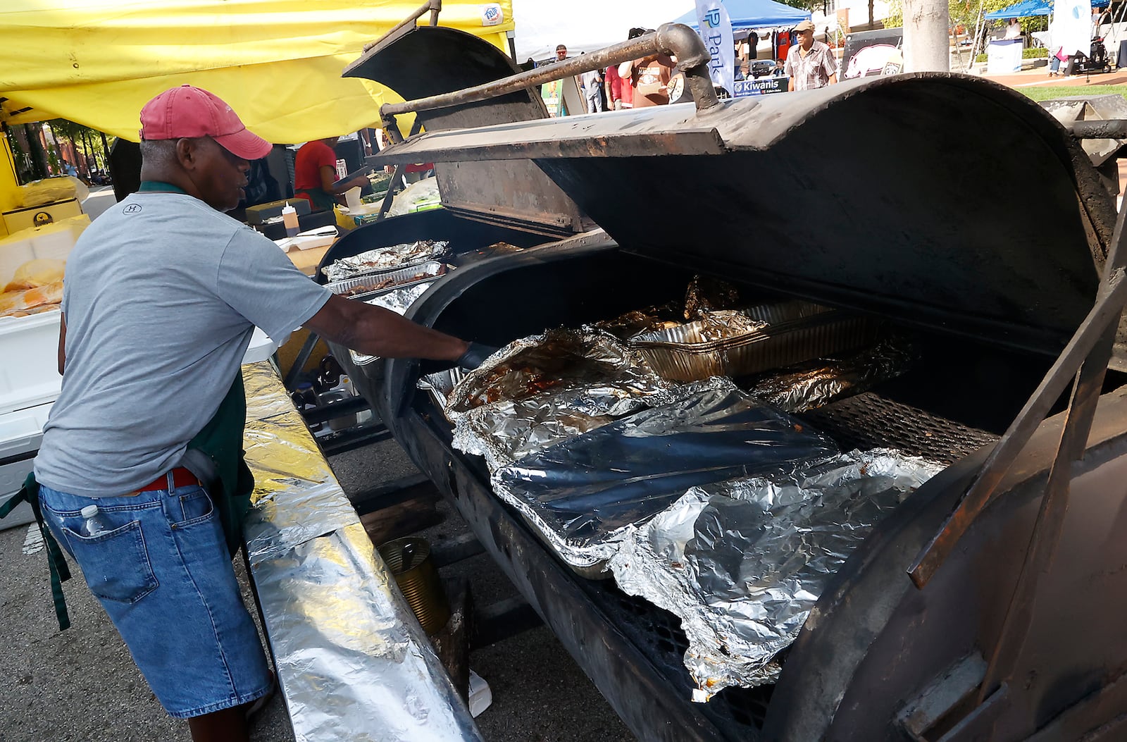 Walter Reeder whips up some BBQ at the Riddles Ribs food truck Friday August 11, 2023 during the Springfield Jazz & Blues Festival. BILL LACKEY/STAFF