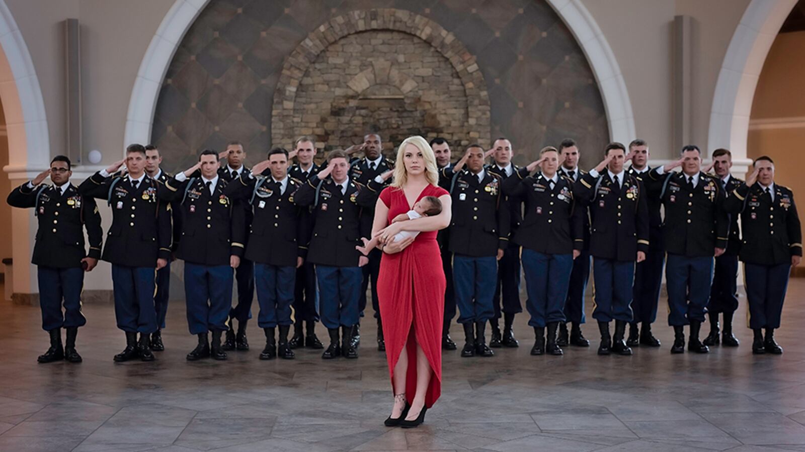 Britt Harris poses with her daughter Christian Michelle Harris, who was named after her father, and fallen soldier, Chris Harris. Behind mother and child, stand members of the 2nd Battalion, 504th Infantry Regiment, 1st Brigade Combat Team, 82 Airborne Division, the division Chris Harris was a member of when he was killed in action.