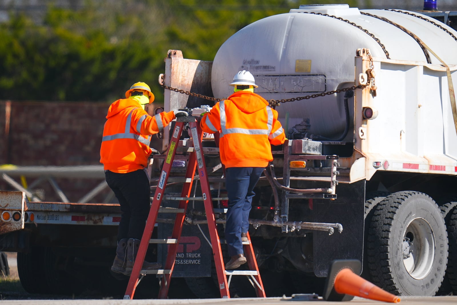 Workers labor on a brine truck at the Texas Department of Transportation Dallas Southwest lot as crews prepare the roads ahead of a winter storm expected to hit the North Texas region, Tuesday, Jan. 7, 2025, in Cedar Hill, Texas. (AP Photo/Julio Cortez)