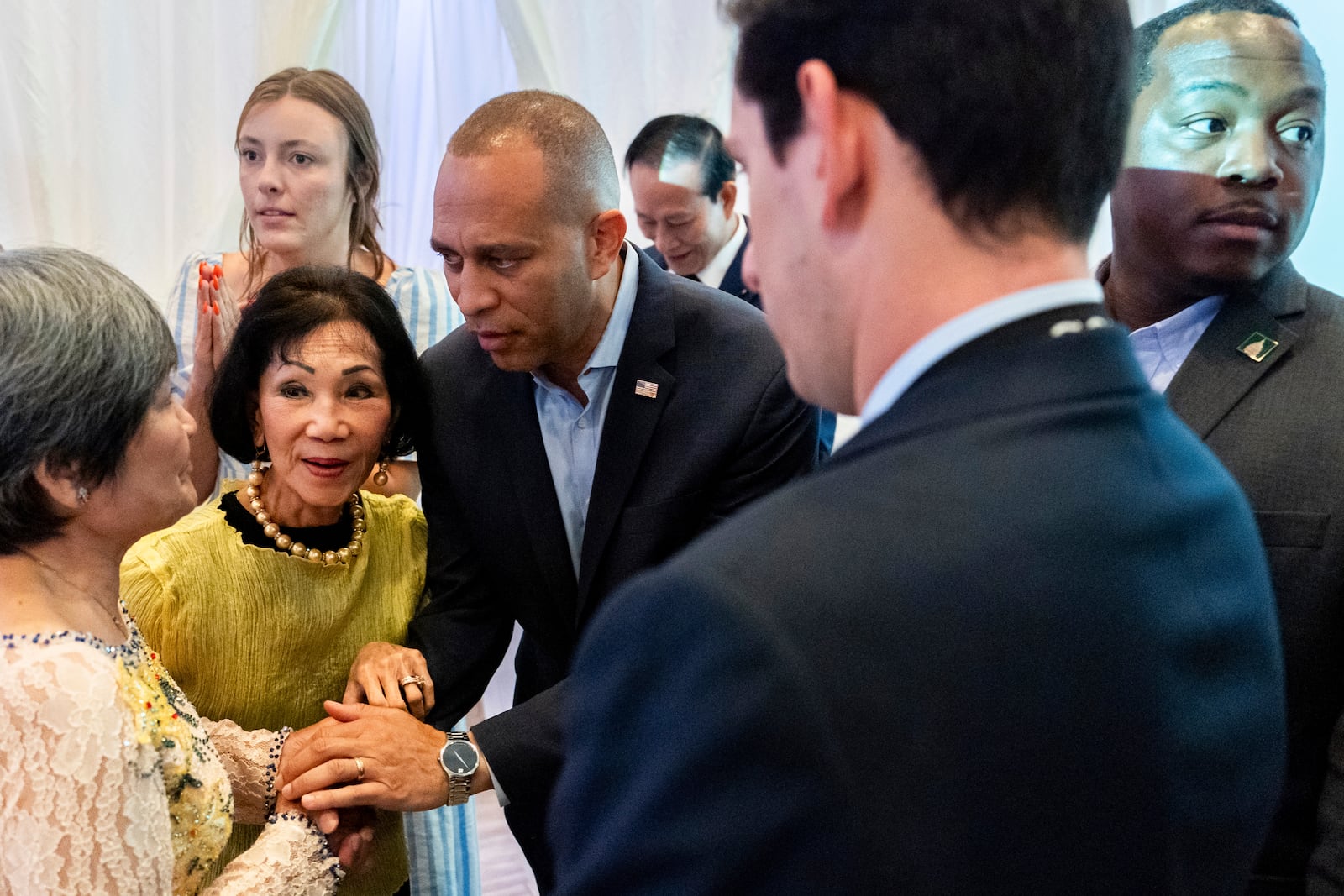 House Minority Leader Hakeem Jeffries, D-N.Y., center, speaks with attendees during a campaign event for Derek Tran at Golden Sea Restaurant, Saturday, Oct. 12, 2024, in Anaheim, Calif. (AP Photo/Julia Demaree Nikhinson)