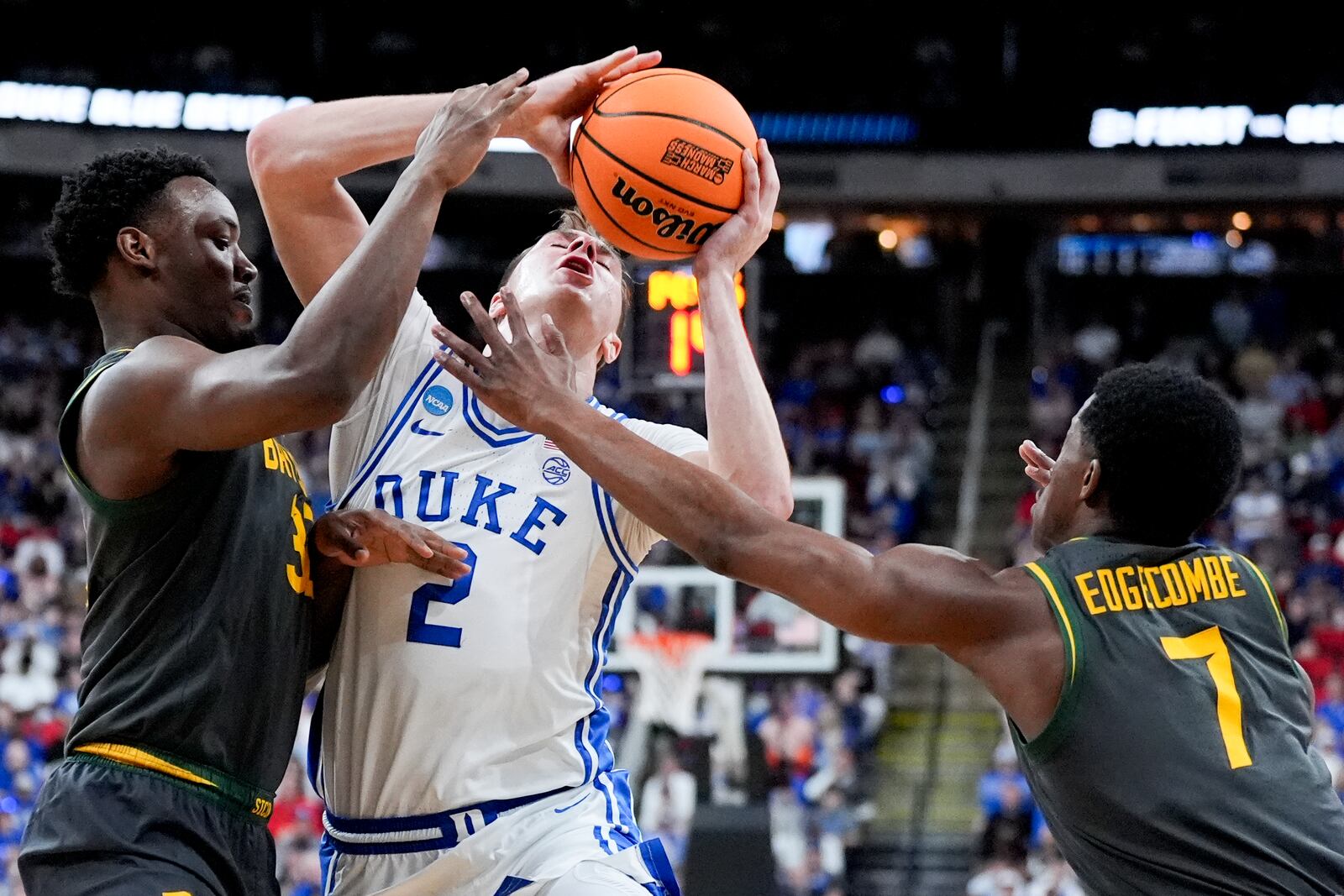 Duke forward Cooper Flagg drives to the basket between Baylor guard Jalen Celestine and guard VJ Edgecombe (7) during the first half in the second round of the NCAA college basketball tournament, Sunday, March 23, 2025, in Raleigh, N.C. (AP Photo/Chris Carlson)