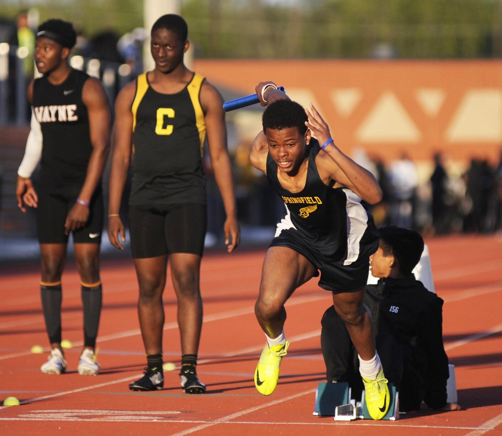 Springfield’s Logan Richardson (right) leads off the 800 relay during the Wayne Inv. on Friday, April 26, 2019. MARC PENDLETON / STAFF