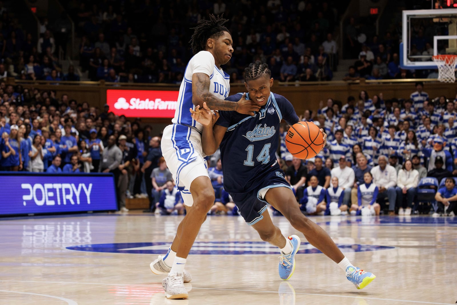 Maine's AJ Lopez (14) is fouled by Duke's Isaiah Evans (3) during the first half of an NCAA college basketball game in Durham, N.C., Monday, Nov. 4, 2024. (AP Photo/Ben McKeown)