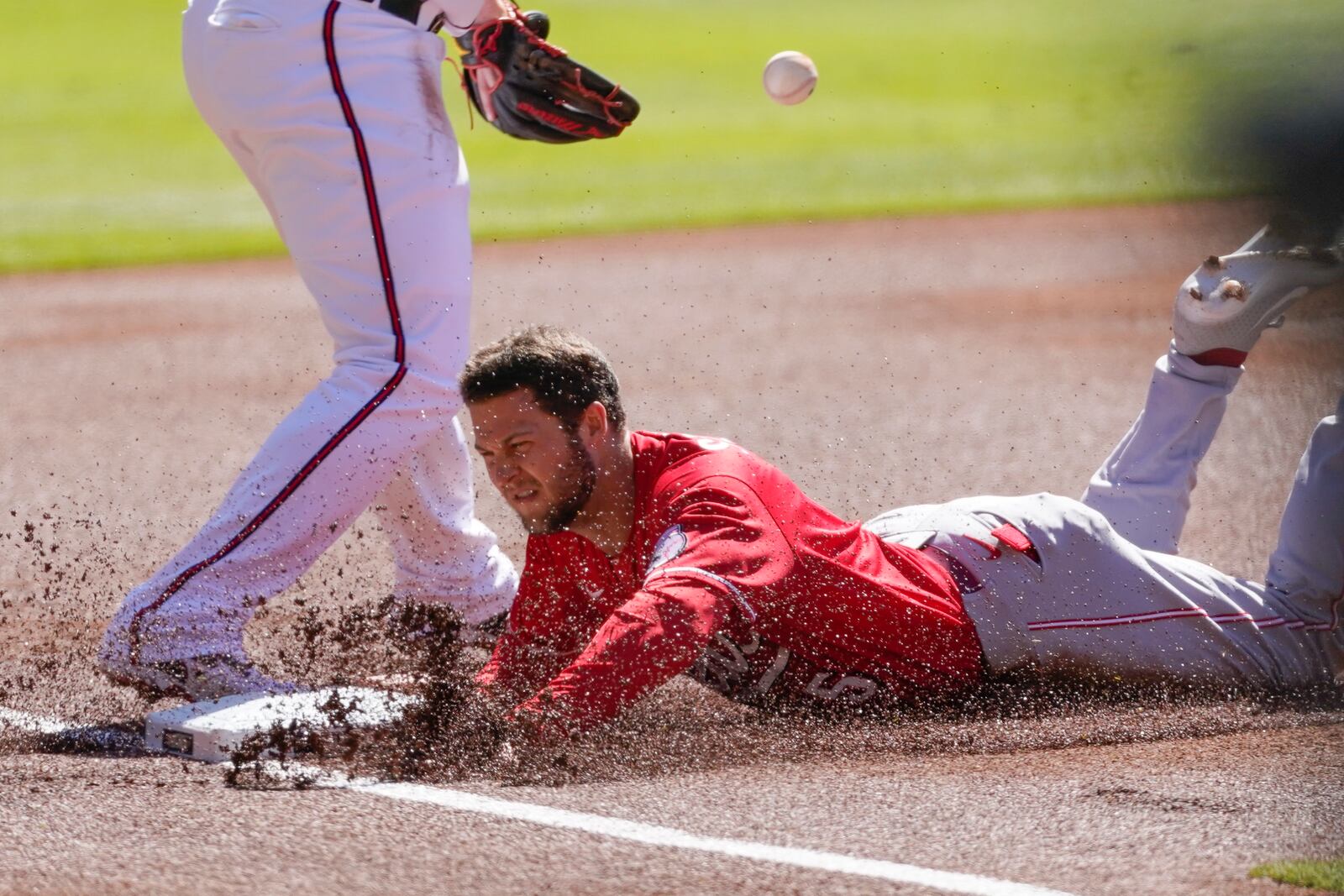 Cincinnati Reds center fielder Nick Senzel (15) advances to third on a Cincinnati Reds Nick Castellanos (2) base hit in first inning during Game 1 of a National League wild-card baseball series, Wednesday, Sept. 30, 2020, in Atlanta. (AP Photo/John Bazemore)