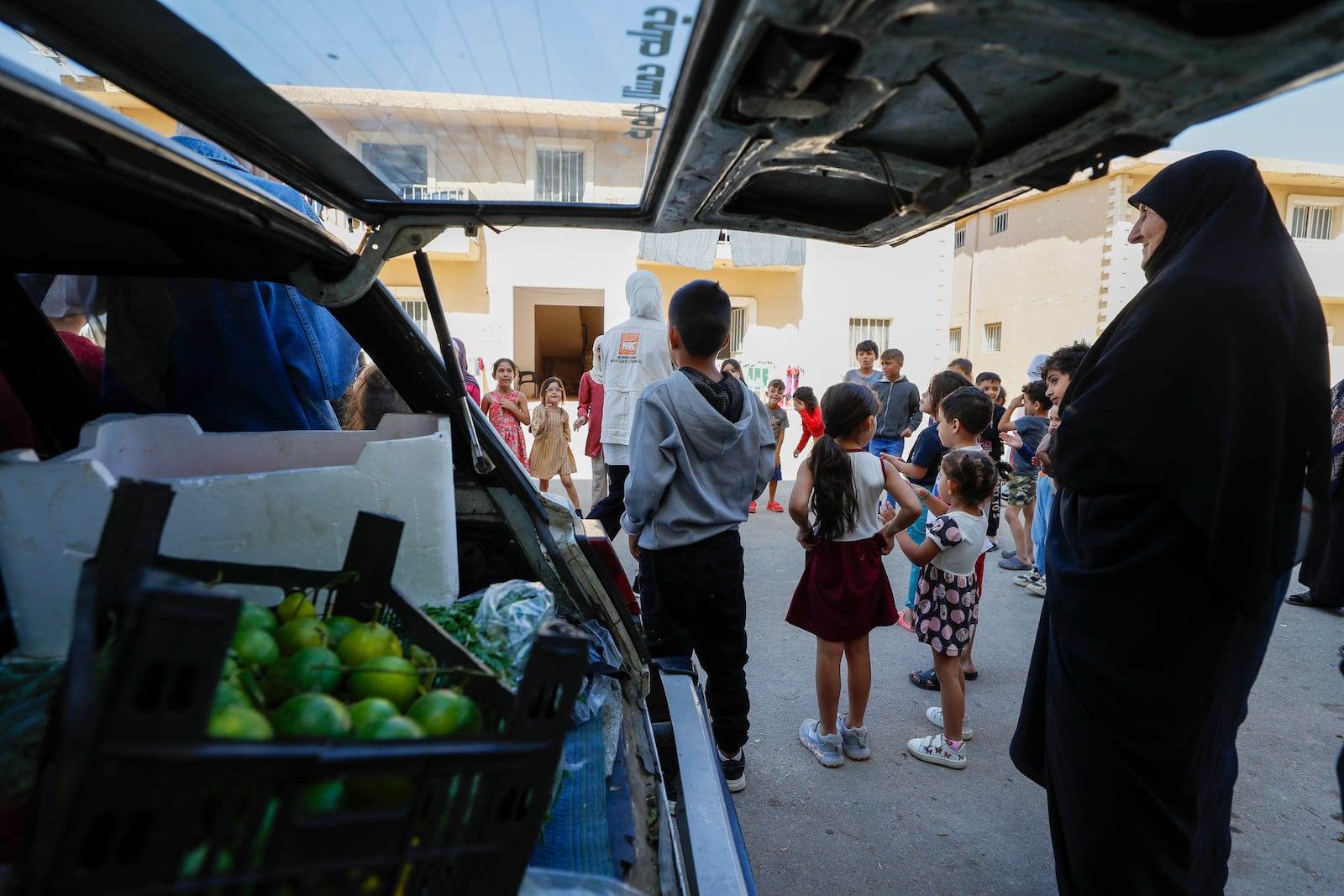 Displaced families fleeing the war in Lebanon, gather at the Herjalleh shelter center in Damascus countryside, Syria, Tuesday, Oct. 15, 2024. (AP Photo/Omar Sanadiki)