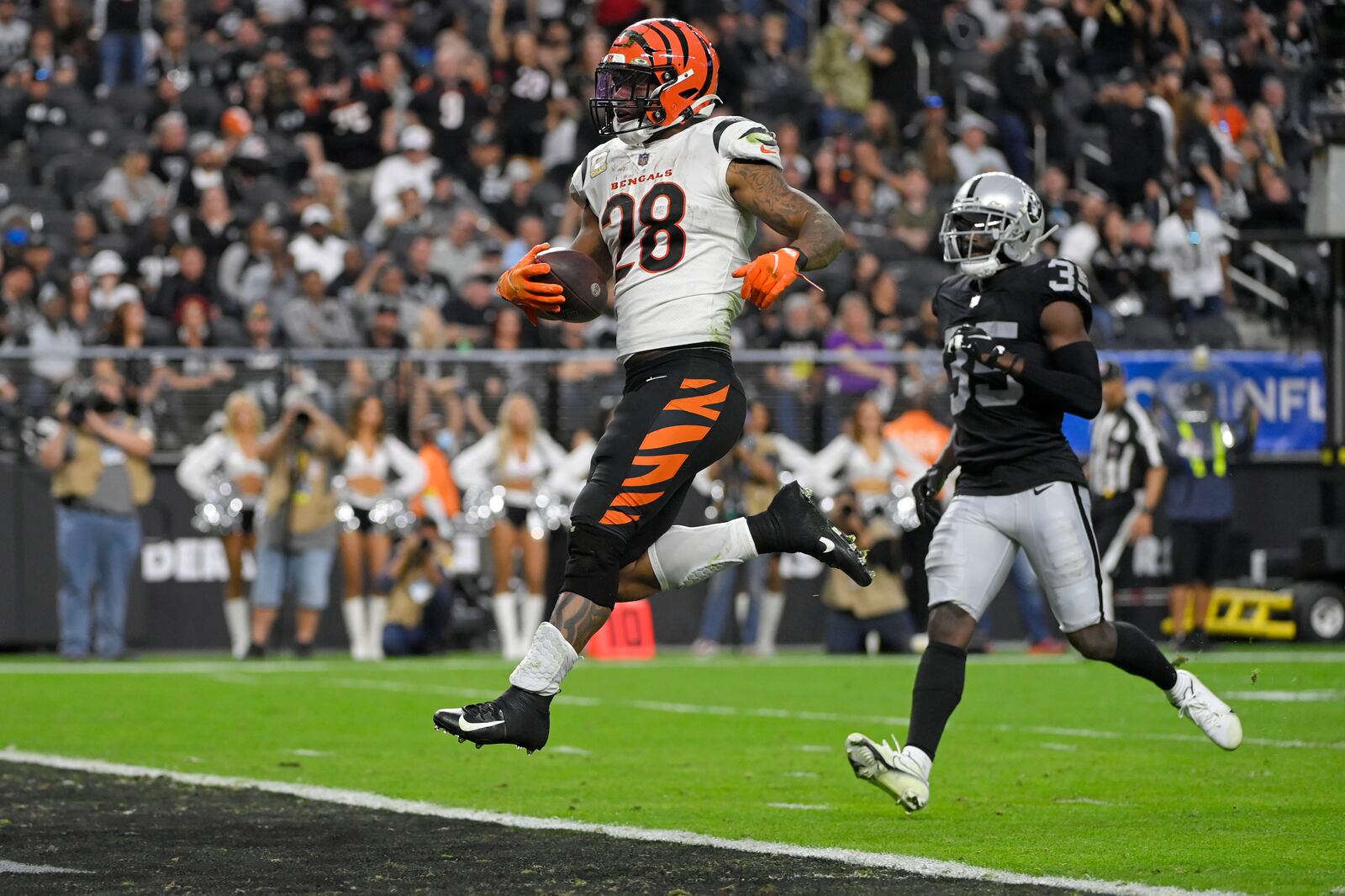 Cincinnati Bengals running back Joe Mixon (28) scores a touchdown against the Las Vegas Raiders during the second half of an NFL football game, Sunday, Nov. 21, 2021, in Las Vegas. (AP Photo/David Becker)