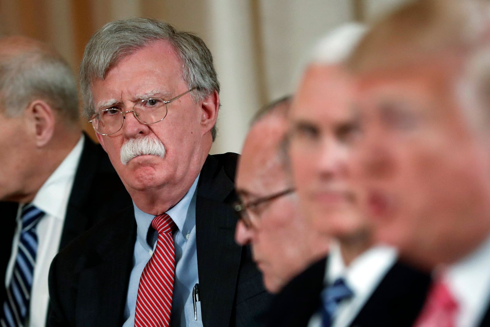 FILE - National security adviser John Bolton, left, listens to President Donald Trump, far right, speak during a working lunch with Japanese Prime Minister Shinzo Abe at Trump' s private Mar-a-Lago club, April 18, 2018 in Palm Beach, Fla. (AP Photo/Pablo Martinez Monsivais)