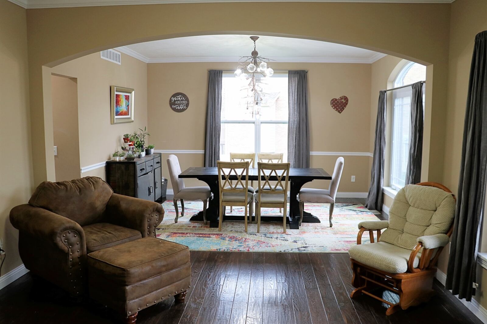 The dining room has an arched window that mirrors the arched interior design.