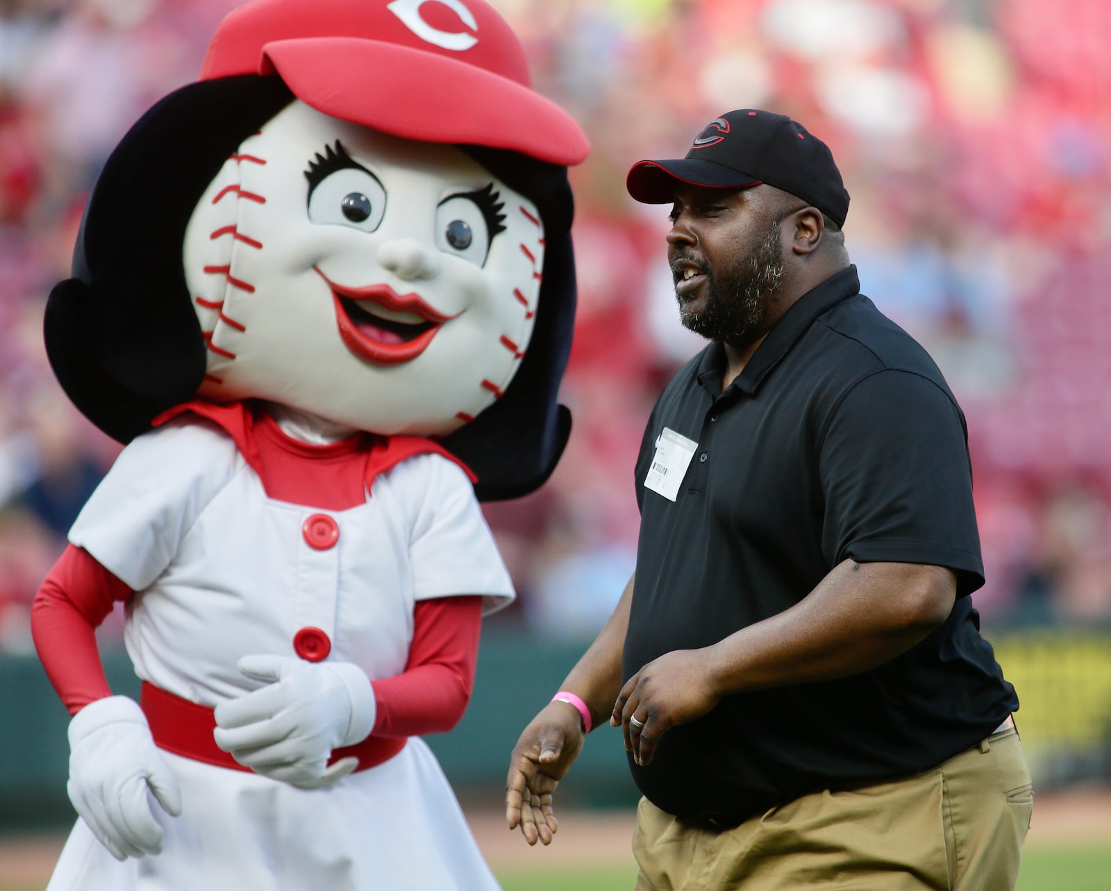 Wilberforce Athletic Director Derek Williams throws out the ceremonial first pitch before a game between the Reds and the Cardinals on Friday, April 22, 2022, at Great American Ball Park in Cincinnati. David Jablonski/Staff