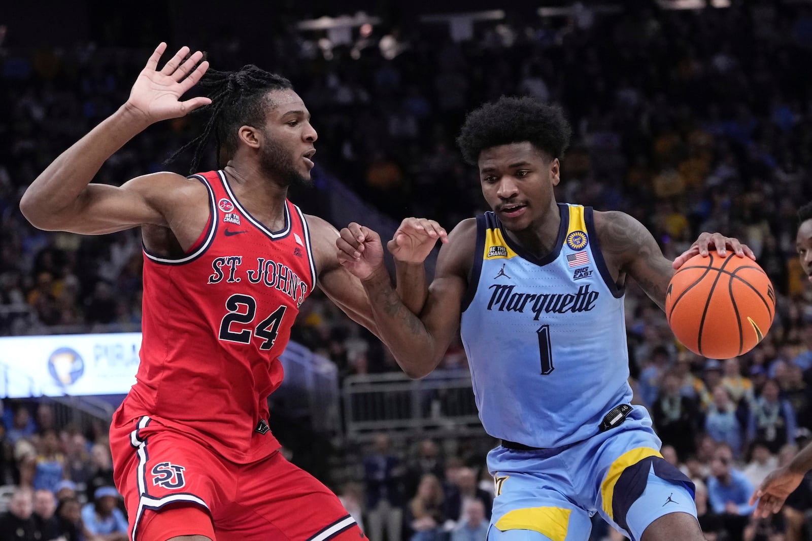 Marquette's Kam Jones drives past St. John's's Zuby Ejiofor during the first half of an NCAA college basketball game Saturday, Mar. 8, 2025, in Milwaukee. (AP Photo/Morry Gash)