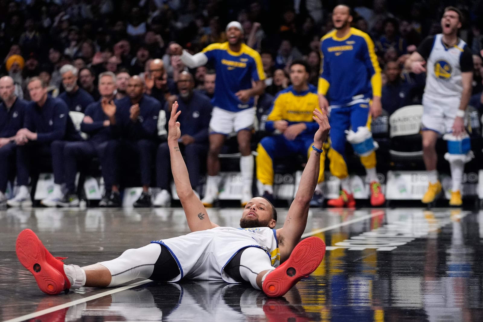 Golden State Warriors' Stephen Curry (30) celebrates after scoring during the second half of an NBA basketball game against the Brooklyn Nets Thursday, March 6, 2025, in New York. (AP Photo/Frank Franklin II)