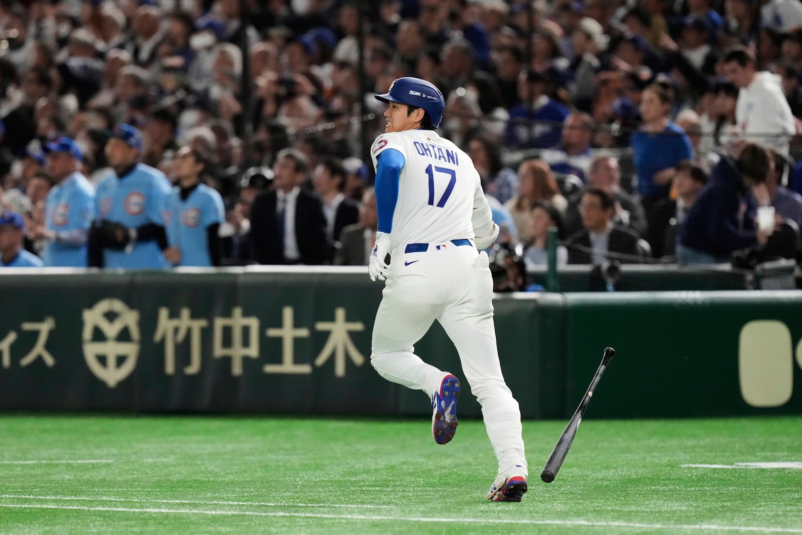 Los Angeles Dodgers' Shohei Ohtani runs out a fly out to left in the first inning of an MLB Tokyo Series baseball game against the Chicago Cubs in Tokyo, Japan, Wednesday, March 19, 2025. (AP Photo/Eugene Hoshiko)