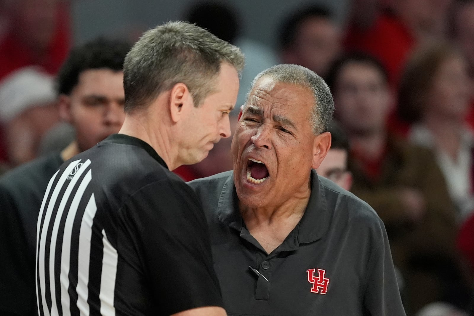 Houston head coach Kelvin Sampson, right, yells at an official during the second half of an NCAA college basketball game against Kansas Monday, March 3, 2025, in Houston. (AP Photo/David J. Phillip)