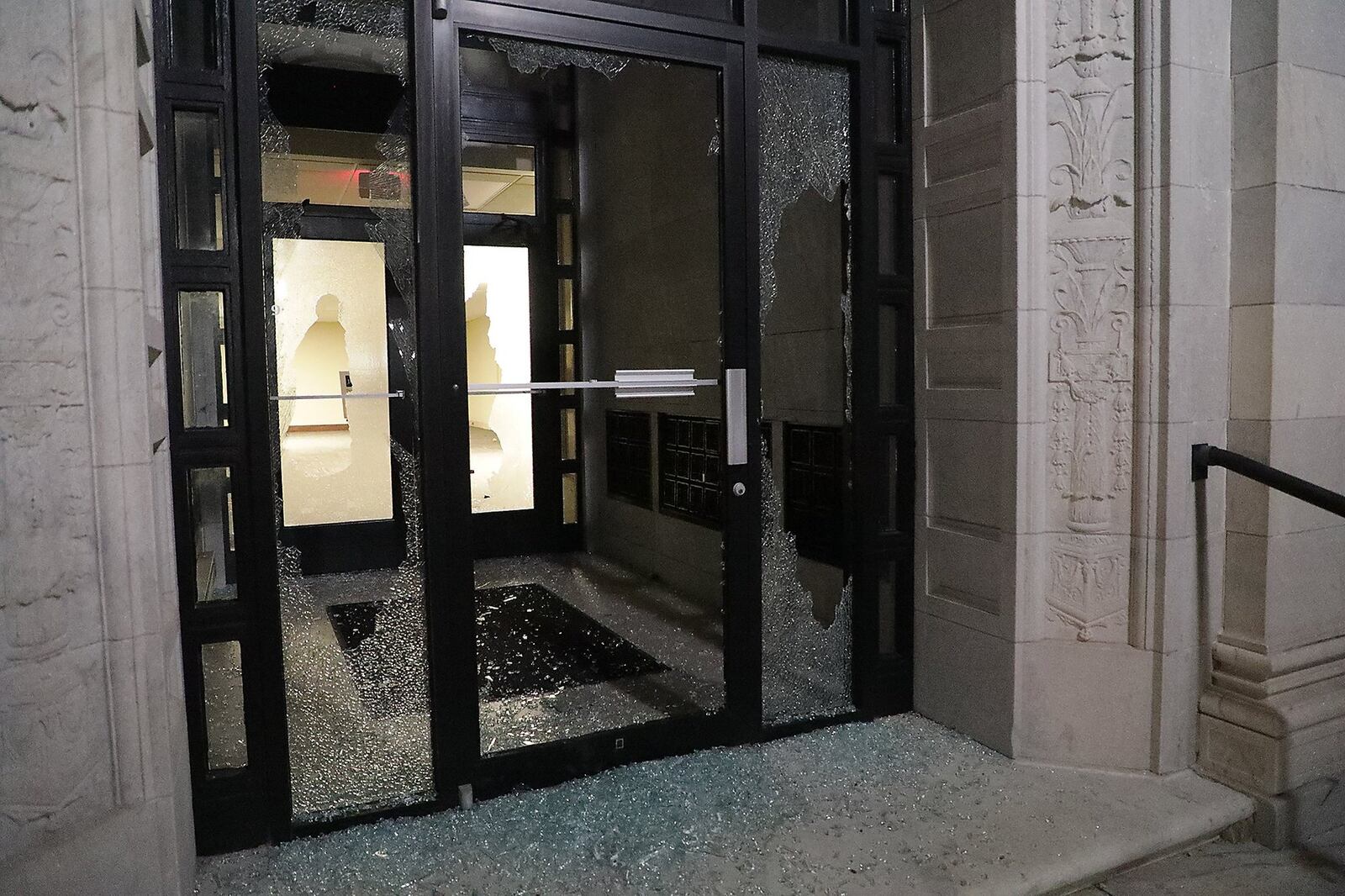 One of the broken windows at the Springfield City Hall Monday. BILL LACKEY/STAFF