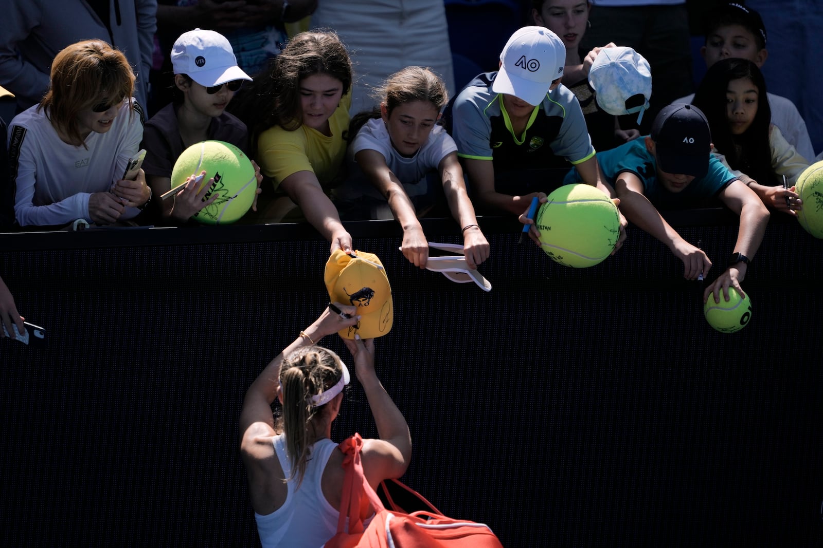 Paula Badosa of Spain signs autographs after defeating Marta Kostyuk of Ukraine in their third round match at the Australian Open tennis championship in Melbourne, Australia, Friday, Jan. 17, 2025. (AP Photo/Ng Han Guan)