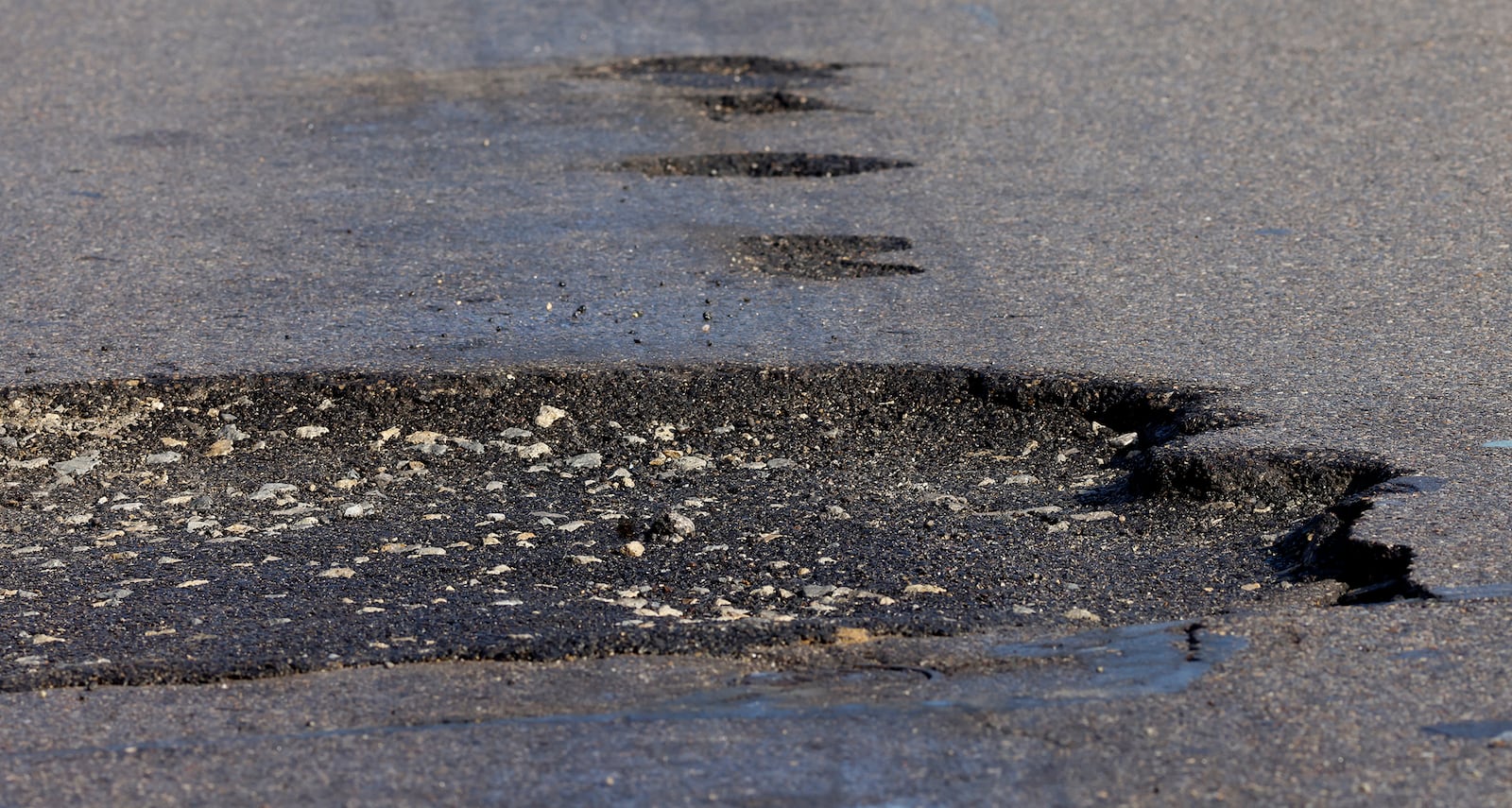 A large pothole on Dryden Road near Main Street in Moraine. MARSHALL GORBY\STAFF