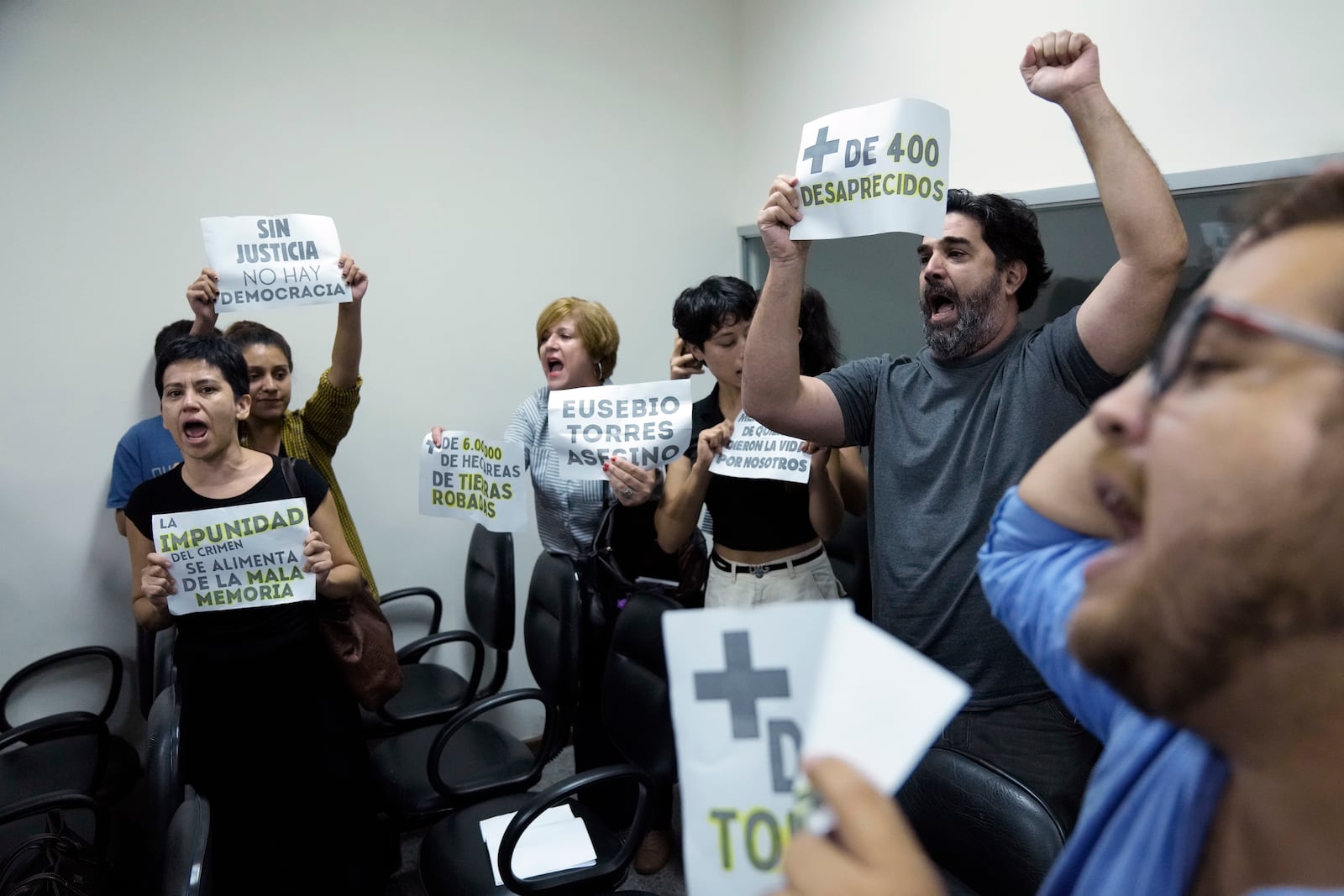 FILE - Former detainees react as retired Police Commissioner Eusebio Torres receives a 30-year sentence for torturing detainees during Gen. Alfredo Stroessner's dictatorship, at Justice Palace in Asuncion, Paraguay, Feb. 20, 2024. (AP Photo/Jorge Saenz, File)