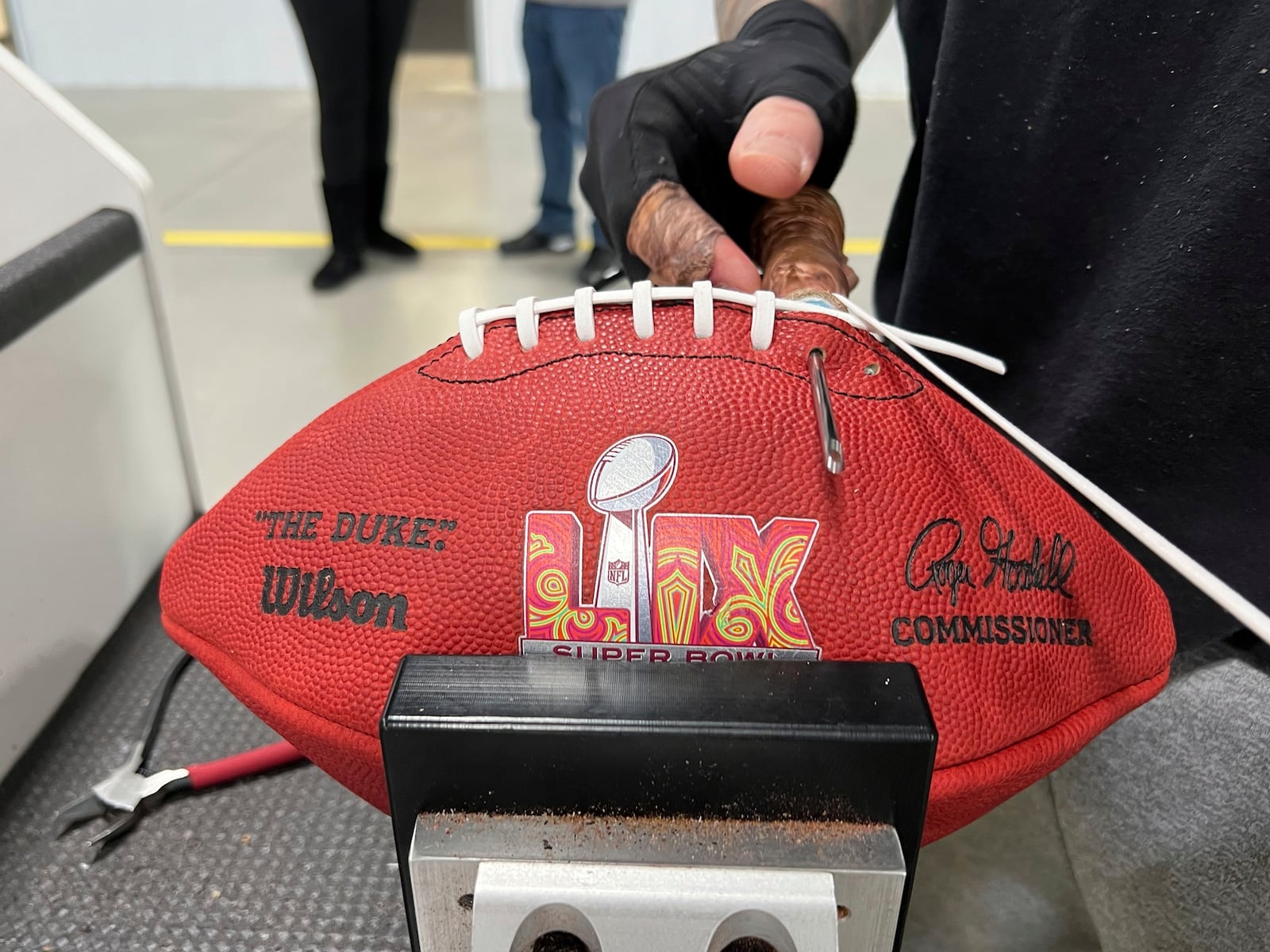 An employee at the Wilson Sporting Goods football factory laces one of the official Super Bowl game balls Monday, January 27, 2025, in Ada, Ohio. (AP Photo/Patrick Aftoora-Orsagos)