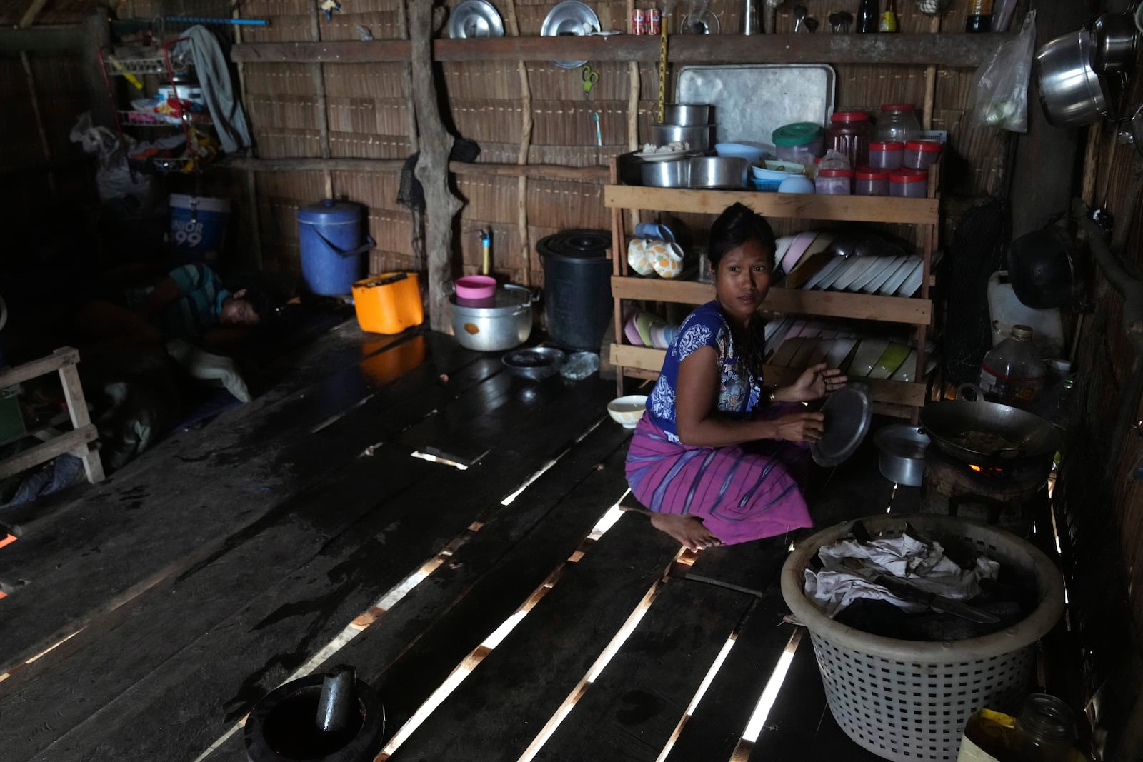 Bonbong Klathale cooks at her house in Moken village at Surin Island in Phang Nga Province, Thailand, Thursday, Dec. 12, 2024. (AP Photo/Sakchai Lalit)