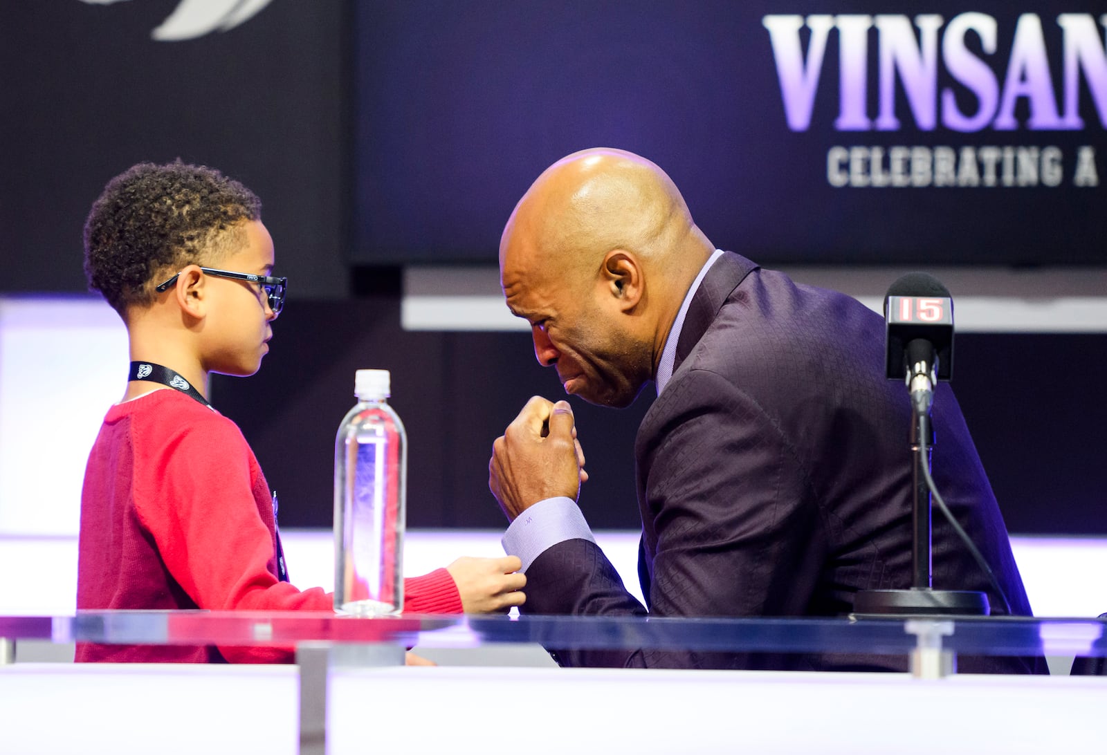 Former Toronto Raptors player Vince Carter is consoled by his son, Vince Carter Jr. while overcome by emotion when speaking to media ahead of his number retirement, before an NBA basketball game between the Toronto Raptors and the Sacramento Kings at the Scotiabank arena, in Toronto on Saturday, Nov. 2, 2024. (Christopher Katsarov/The Canadian Press via AP)