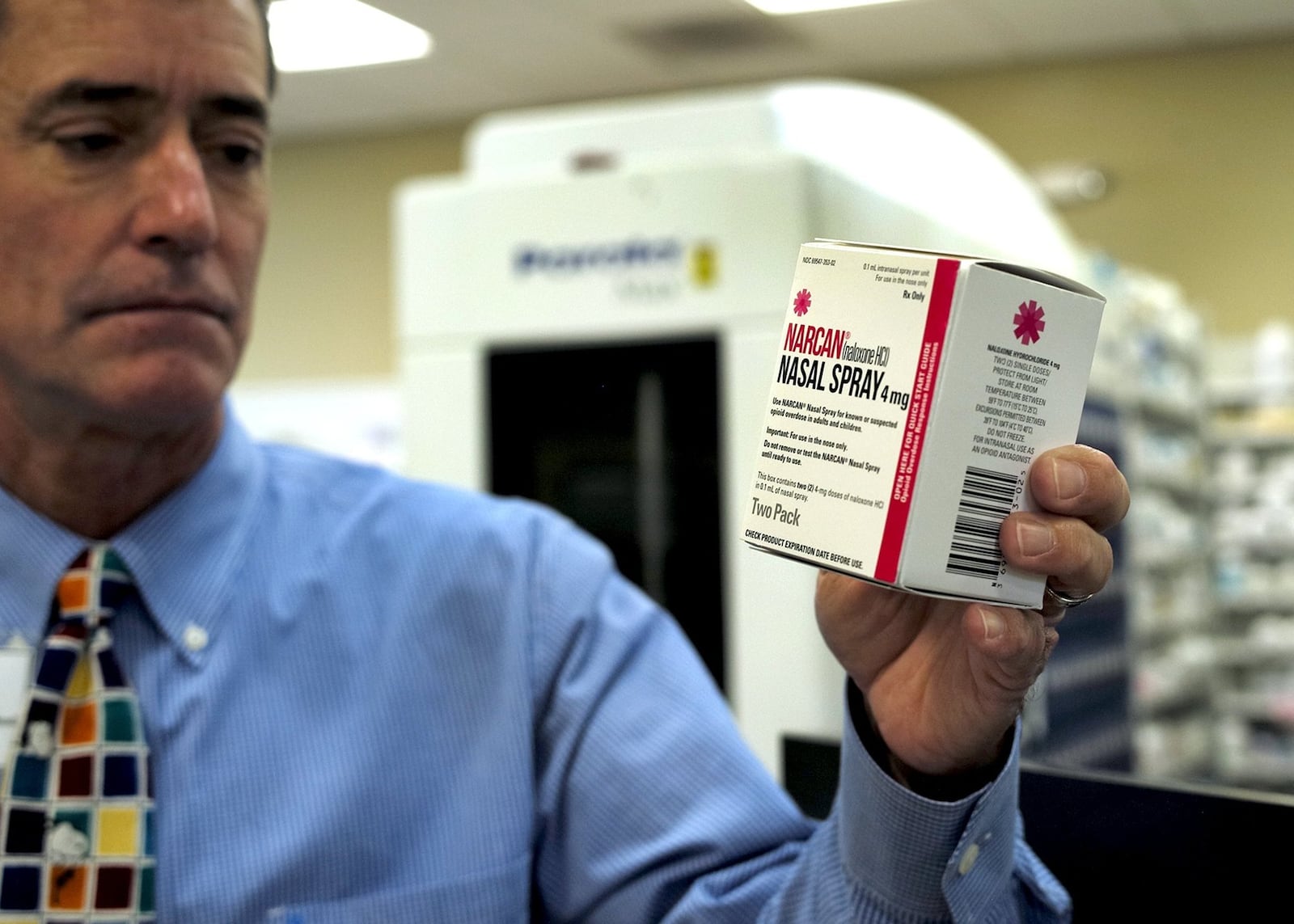 In a 2016 photo, Eric Juergens, a pharmacist at Madison Avenue Pharmacy, shows a box of Narcan nasal spray Friday. Narcan, a drug that can reverse an opioid overdose, will be available in pharmacies across the state and people can get the drug without a prescription. BIll Lackey/Staff